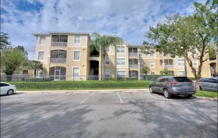 Unparalleled location in the highly sought-after guard-gated Windsor Palms Resort Community. This tastefully furnished 3rd-floor condo is just steps from the clubhouse and offers a split 2-bedroom, 2-bathroom floor plan with a private balcony perfect for relaxing with morning coffee. Both bedrooms feature walk-in closets, and the unit includes a full-size, large-capacity washer and dryer in the laundry closet. Waterproof vinyl flooring was installed throughout the living room, bedrooms, and bathrooms four years ago. The community provides exceptional resort-style amenities including a heated Olympic-sized pool, hot tub, kiddie pool, sun deck, fitness center, tennis, volleyball, basketball, movie theater, gaming arcade, ping-pong, BBQ area, playground, business center, tiki bar, and an onsite convenience store. Internet, cable TV, valet trash service, and access to all amenities are included. Windsor Palms offers an unbeatable location—only 3 miles to Margaritaville for shopping and dining, 2.5 miles to Walmart, and 3 miles to the entrance of Disney World—with quick access to major highways including I-4, 429, 417, and 192. Ideal as a primary residence, vacation home, or investment property.