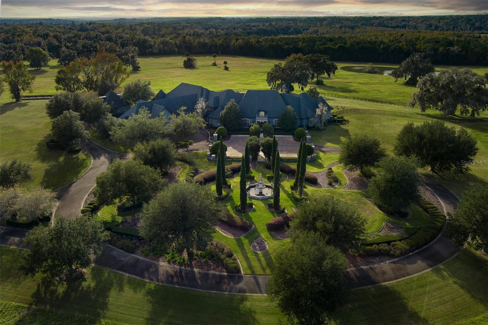 Located on one of the region’s highest elevations, this approximately 160 acre premier estate commands breathtaking panoramic views of Florida's pristine countryside. Nestled behind a beautifully landscaped entrance and a long, winding driveway, Mardanza Farm is framed by majestic, mature oak trees that enhance the property's timeless beauty and sense of arrival. At the heart of the estate, a masterfully crafted French Provincial residence showcases exceptional architecture, refined design elements, and superior craftsmanship throughout. Designed for both grand-scale entertaining and everyday luxury, the residence features a chef's kitchen, butler's pantry, and elegant gathering spaces that flow seamlessly outdoors. The resort-style outdoor living area is centered around a spectacular infinity-edge pool, creating the illusion of merging with the distant horizon and offering a truly unforgettable setting to relax and take in the sweeping views. Combining extraordinary privacy, natural beauty, and unparalleled craftsmanship, Mardanza Farm represents one of the area's most distinguished legacy estates. Additional acreage is available.