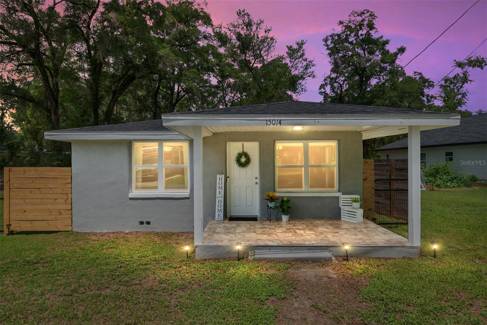 Set on an expansive nearly quarter-acre corner parcel framed by new fencing and wide open skies, this charming midcentury cottage offers a rare sense of serenity that is increasingly difficult to find. Mature trees, generous outdoor space, and the quiet rhythm of a slower pace create a setting that feels grounded, inviting, and full of possibility. Whether envisioned as a first home, an investment opportunity, or a place to simplify and reconnect, the property carries a warmth that feels both approachable and enduring. Built in 1955, the home embraces the enduring appeal of classic architecture paired with practical, thoughtful updates that support modern living. Inside,the living areas balance intimacy with functionality, offering an atmosphere that feels collected over time rather than manufactured. Every corner reflects the kind of character that gives smaller homes their lasting emotional appeal. The kitchen and adjoining living spaces create an effortless cadence for daily life, while the 2 bedroom layout offers flexibility for guests, a home office, creative space, or long term rental potential. The overall footprint lives intentionally, prioritizing comfort, simplicity, and connection over excess. Recent improvements, including a newer roof and HVAC system installed in 2021, add meaningful value and peace of mind while preserving the home’s original charm and authenticity. Outside, the oversized quarter acre lot becomes an extension of the living experience itself, offering room to garden, entertain, expand, store recreational equipment, or simply enjoy the luxury of open space beneath the Florida sky. The newly installed front fence adds both visual character and functionality, framing the property with a welcoming sense of definition while enhancing privacy and curb appeal. As a corner lot, the setting feels especially open and expansive, with a presence that immediately stands apart from neighboring properties.Two off-street parking spaces provide everyday convenience. Cozy in size yet expansive in feeling, this is a property defined not by excess, but by opportunity, character, and the enduring appeal of land and simplicity. The result is a home with soul, offering the kind of flexibility and authenticity that continues to resonate in today’s market.
