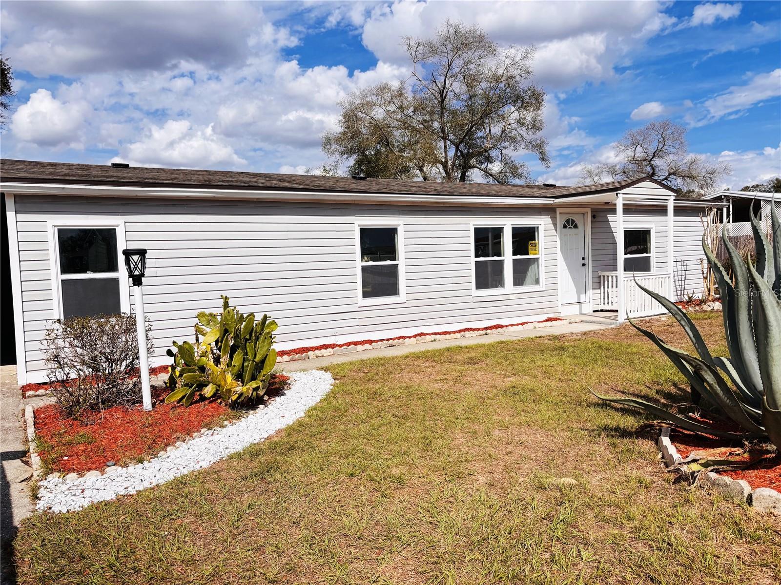 Completely Renovated and MOVE IN READY! This beautiful updated 3 bedroom, 2 bath home sits on an 0.25 Acres LOT and NO HOA. Offers a modern open concept layout with designers finishes throughout. The stunning kitchen features shaker-Style cabinetry, custom wood countertops, dark hardware, updated lighting, stainless steel appliances and plenty of cabinet space. The spacious Walk-in Pantry adds both functionality and extra storage space. Enjoy Luxury vinyl flooring throughout, fresh interior an exterior paint, upgraded fixtures, spacious bedrooms, and abundant natural light. This home also offers an impressive amount of closet and storage space. Major updates include 2024 Roof, 2025 A/C System, Water Heater and Kitchen Appliances. Washer and Dryer are also included, making this home truly turnkey and ready for its next owner. 

Step outside to a covered back patio area perfect for relaxing and entertaining, The property also includes TWO storage sheds plus a dedicated Workshop, providing ample storage and extra space for tools and equipment. A spacious TWO car carport adds additional covered parking and convenience. 

Conveniently Located just minutes from the I75 exit and the highly desirable State Rd 200, offering quick access to shopping, dining, medical facilities. Located near the popular Top of the World community and just a short drive to the World Equestrian Center.

This is not your average manufactured home, thoughtfully remodeled from top to bottom. Schedule your private showinng today