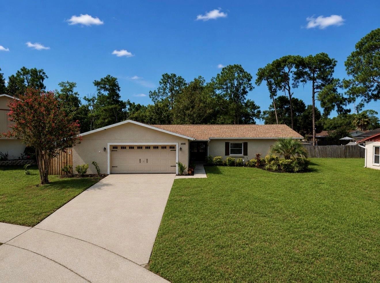 Nestled on a quiet cul-de-sac in the highly desirable Bloomingdale community, this beautifully maintained pool home sits on an oversized acre lot with a peaceful preserve-like setting and a creek behind the property, offering exceptional privacy all while being conveniently located near top-rated schools, shopping, dining, parks, golf, and easy access to major commuter routes. Double front doors welcome you into a bright, open floor plan featuring wood-look flooring, elegant crown molding, updated lighting, modern finishes, and tasteful window treatments throughout. The updated kitchen is the heart of the home with custom cabinetry, granite countertops, stainless steel appliances, stylish pendant lighting, and a breakfast bar overlooking the family room and solar-heated screened pool. The spacious primary suite features an updated bath with a floor-to-ceiling tiled walk-in shower, while the secondary bath has also been beautifully renovated with custom cabinetry and granite countertops. Additional upgrades include energy-efficient double-hung windows, hurricane shutters, updated door hardware, modern electrical switches and outlets, raised-panel interior doors, and an oversized garage accessed through a spacious laundry room with built-in cabinetry. Outdoor living shines with an expansive screened lanai, paver pool deck, fire pit area, mostly fenced backyard, and a large storage shed/workshop all overlooking the tranquil creek and lush natural surroundings. Move-in ready and meticulously maintained, this exceptional Bloomingdale home offers the perfect combination of comfort, style, convenience, and Florida living.