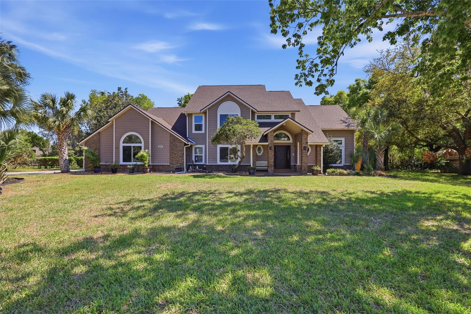 One or more photo(s) has been virtually staged. Price Improvement Welcome to your private lakefront magnificent retreat in the highly desirable and established Summerhaven community of DeBary with an optional HOA of $150 yr! This beautifully maintained 5-bedroom, 4-bath 3868 Sq Ft remodeled home features a **propane-heated, in-ground gunite pool** and is perfectly situated on an expansive .71-acre cul-de-sac lot with no rear neighbors, backing up to a serene lake—ideal for peaceful views and fishing right from your backyard.

From the moment you arrive, you’ll appreciate the inviting curb appeal, mature landscaping, and quiet setting. Step inside to soaring ceilings, abundant natural light, and a thoughtfully designed floor plan featuring laminate flooring and ceramic tile throughout. Architectural details such as plant shelves, chair railings, and open spaces add character and warmth to the home. All of the rooms are generously sized, providing comfort and flexibility for everyday living and entertaining.

At the heart of the home is a gourmet chef’s kitchen, complete with maple glazed cabinetry, granite counters, double ovens, a wine fridge, closet pantry, recessed lighting, and ample counter space—perfect for both everyday living and hosting guests. The kitchen flows seamlessly into multiple living areas, including a spacious family room with a decorative fireplace, dining room, living room and additional flex space ideal for a home office or bonus room.

The primary suite is conveniently located on the first floor and offers a spacious retreat with quartz countertops in the primary bath, dual vanities, a soaking jetted tub, and a separate shower. The suite also features direct access to the pool area, creating a true indoor-outdoor living experience. Also located downstairs is an additional bedroom and full bathroom—perfect for guests, in-laws, or a private home office setup.

Upstairs, you’ll find three spacious 3 bedrooms, 2 full bathrooms, jack and jill bath to connect 2 bedrooms, and a versatile loft area—perfect for a media room, playroom, or additional living space. The home also offers abundant storage throughout.

Step outside to your own private outdoor oasis featuring the propane-heated, in-ground gunite pebble tech pool with a large screened enclosure and covered pavered lanai—perfect for year-round enjoyment. The backyard backs to conservation and a peaceful lake, offering both privacy and a beautiful natural backdrop.

Additional features include an inside laundry room with folding table and cabinets, a side-entry two-car garage, water softener system, internal vacuum, generator hookup, and sprinkler system on a well. Major updates provide peace of mind, including a brand-new roof in 2026, HVAC systems replaced in 2016, new windows and sliding glass doors in 2024 and a new drain field installed just two years ago.

Ideally located just minutes to medical facilities, shopping, dining, and I-4, with easy access to SunRail, you’re only 30 minutes to Orlando and approximately 25 minutes to Daytona Beach—making this location as convenient as it is peaceful.

Take advantage of a rare opportunity to secure a significantly lower monthly payment! The seller is contributing approximately $14,500 toward an interest rate buy-down, allowing qualified buyers to achieve an estimated 5.75 interest rate (with 20 down)—a major savings in today’s market. This incentive is available with a full-price contract, making this home not only beautiful, but an incredible value.