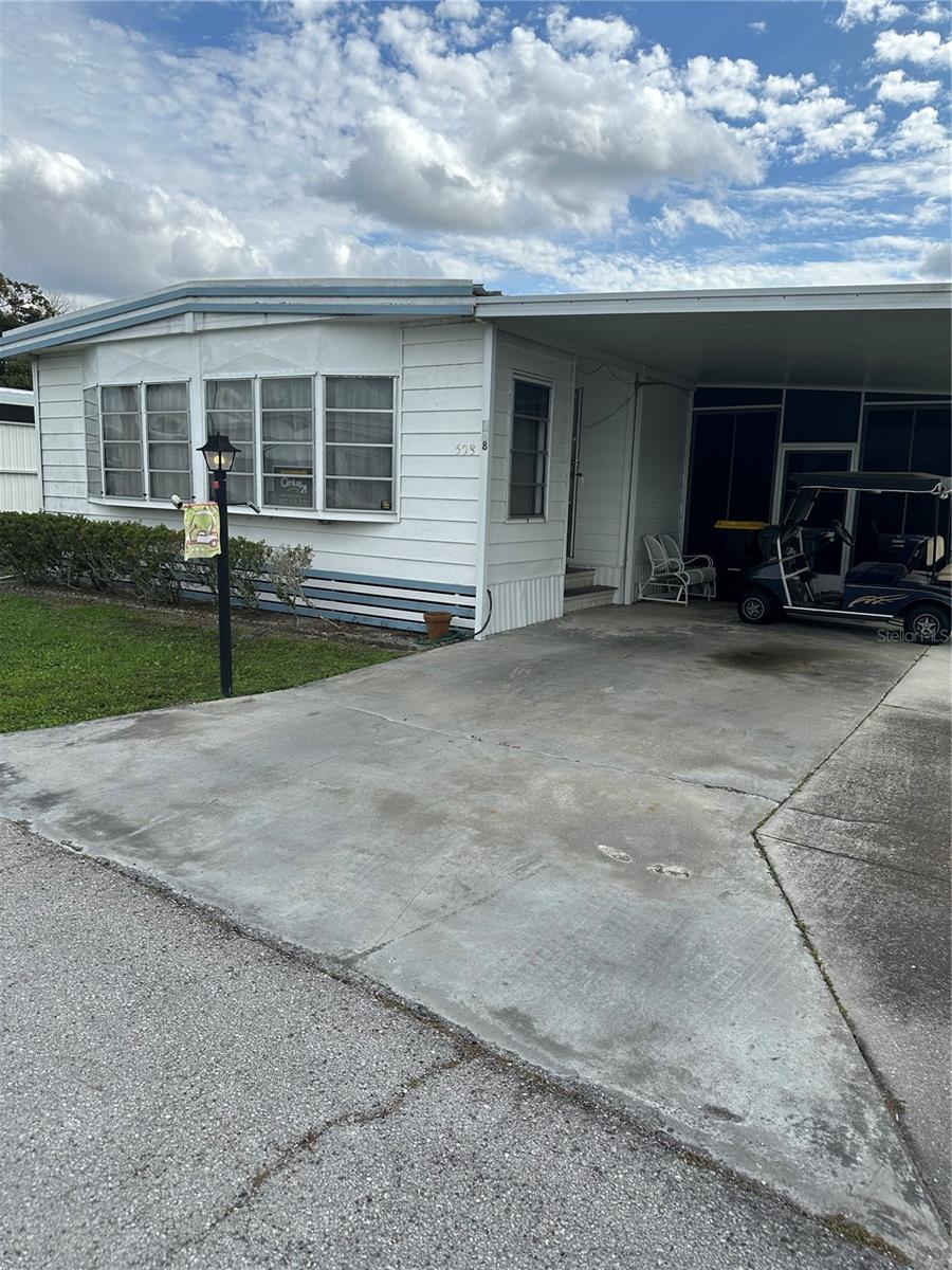 ENJOY THIS WELL KEPT FURNISHED MANUFACTURED HOME IN GATED 55 AND OVER COMMUNITY. THIS PROPERTY IS IN A CO-OP.  OUTSIDE OF HOME RECENTLY PAINTED 2026. THE AIR CONDITIONER IS NEW IN 2025. KING AND QUEEN SIZE BEDS WITH MATCHING DRESSERS, SOFA BED, 70 IN TV, LEATHER COUCH AND ROCKING RECLINERS. SUN ROOM HAS TV WITH LARGE BAR WITH STOOLS. LAMINATE FLOORS IN ALL ROOMS EXCEPT BEDROOMS HAVE CARPET. BRING YOUR TOOTHBRUSH, EVERYTHING ELSE IS READY FOR YOU TO MOVE IN. ENJOY SCHEDULED ACTIVITIES COMMUNITY HEATED POOL, LIBRARY, SHUFFLEBOARD, HORSESHOES, BILLIARDS, AND MORE. TRAILER STORAGE AREA AND LAUNDRY. SELF CONTAINED WATER AND SEWER SYSTEM WITH BACKUP GENERATORS. NO PETS EXCEPT SERVICE ANIMALS. NO MOTORCYCLES. THE $11,000 SHARE IS INCLUDED IN SALES PRICE. LAKE HENRY IS AN 810 ACRE PRIVATE LAKE.