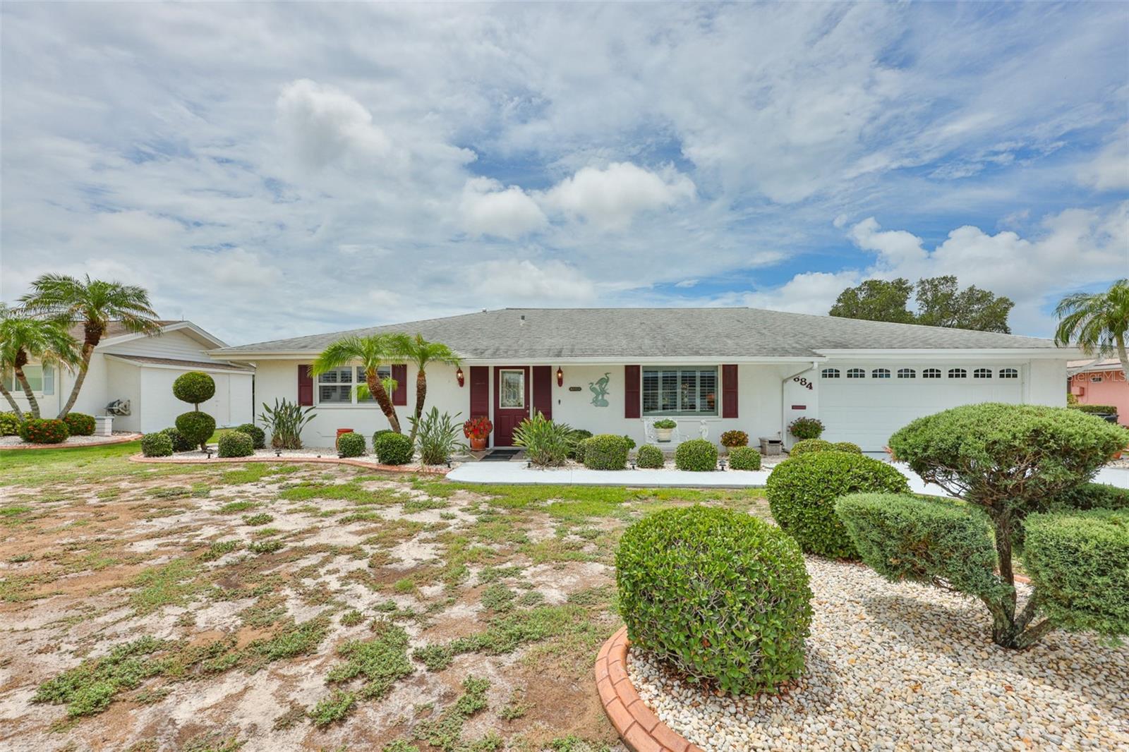 WELCOME TO YOUR CHARMING SUN CITY CENTER RETREAT — NO HOA! Discover this well-maintained home ideally located on the desirable north side of Sun City Center. From the moment you arrive, you’ll appreciate the exceptional curb appeal featuring Florida-friendly landscaping, a painted driveway and walkway, upgraded concrete curbing, & a serene and expansive rear green space. Step inside and feel instantly at home. The bright interior showcases luxury vinyl plank flooring, complementary tiles, and an abundance of natural light throughout. Generously sized rooms and ample closet space provide both comfort and functionality, giving you the flexibility to truly make this home your own. The centrally located kitchen offers wood cabinetry, black appliances, and coordinating Corian countertops, along with a convenient pass-through to the oversized, climate-controlled Florida room. With built-in storage and versatile space, this area is perfect for entertaining or simply relaxing with family and friends. The spacious primary suite features a large closet and a private ensuite bath with a handy walk-in shower. A comfortable guest bedroom and adjacent hall bath provide ideal accommodations for overnight guests. An additional bonus room offers flexibility as an office, den, or even a third bedroom use the space for whatever suits your lifestyle needs. Enjoy Florida living at its best in the enclosed rear lanai, where you can unwind while taking in peaceful views of the open green space—perfect for birdwatching, gardening, or simply enjoying the outdoors. Recent upgrades include a 2021 ROOF & HVAC system, offering added peace of mind. Located in the highly sought-after 55+ golf cart community of Sun City Center, residents enjoy access to pools, fitness centers, clubs, sports, golf, pickleball, arts and crafts, and more—all just a short drive to beaches, airports, shopping, and entertainment. Whether you're looking for a full-time residence, seasonal retreat, or investment opportunity, this home offers exceptional value and potential. Schedule your private showing today and start enjoying the Sun City Center lifestyle.