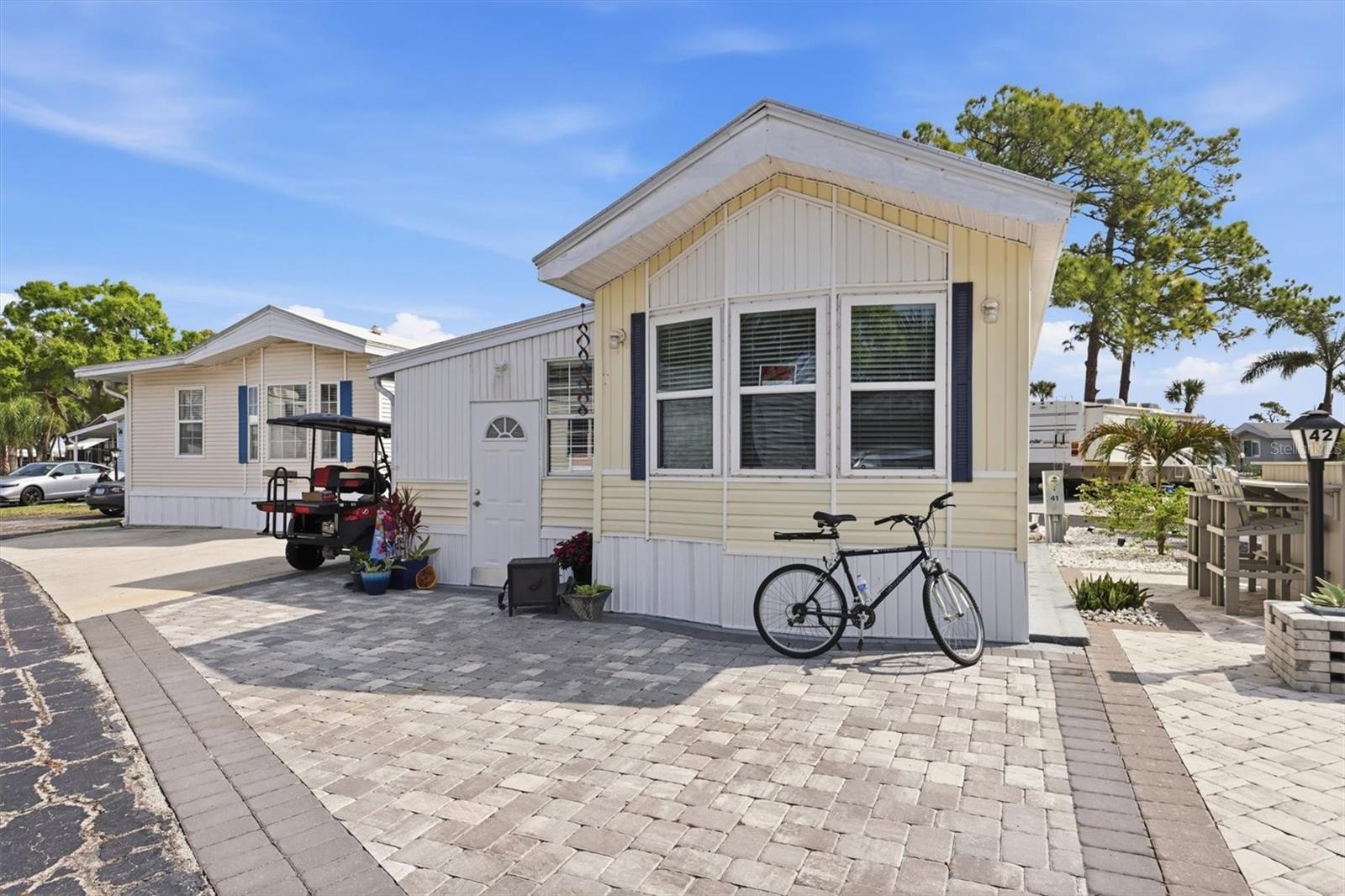 Welcome to Sarasota Lakes, a gated and amenity-rich community perfectly positioned in the heart of Sarasota. This beautifully updated FURNISHED 1-bedroom, 1.5-bath residence offers nearly 1,000 square feet of thoughtfully designed living space, ideal for year-round living, a seasonal retreat, or a low-maintenance second home. Step inside to find vaulted ceilings that create an open and airy feel, complemented by recently updated vinyl plank flooring and subflooring throughout. The fully remodeled kitchen serves as the centerpiece of the home, featuring updated cabinetry, sleek countertops, and stainless steel appliances, all designed for both functionality and style. Modern fixtures and finishes throughout add a fresh, move-in-ready appeal. Outdoor living is just as inviting, with newly installed brick pavers creating the perfect space to relax or entertain in your own private setting. Residents of Sarasota Lakes enjoy a low HOA and access to an impressive array of amenities, including a heated pool and spa, tennis courts, a basketball court, playground, and shuffleboard—offering something for everyone in this vibrant, gated community. Ideally located just minutes from University Town Center (UTC), downtown Sarasota, and some of Florida’s most renowned Gulf Coast beaches including Lido Key, Siesta Key, and Anna Maria Island, this property delivers both convenience and lifestyle. Whether you’re looking for a full-time residence, a winter escape, or a smart investment opportunity, this home checks all the boxes.