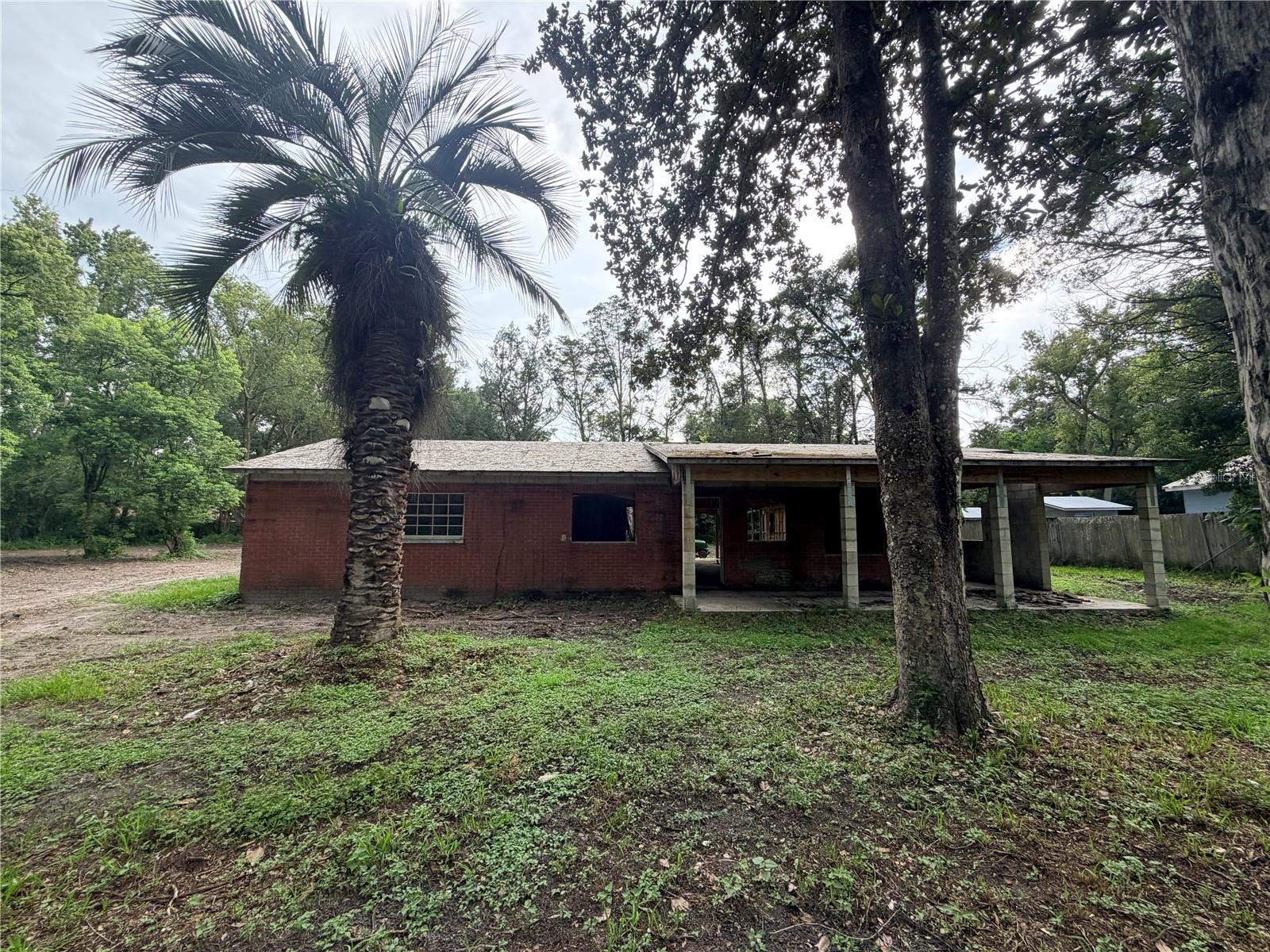 Opportunity is calling! To all visionaries, builders, investors, and those looking to sink their teeth into a new project... this is where potential meets a physical address.

Every great transformation starts with a blank canvas, and this one is ready for its next chapter.

Nestled on 0.58 acres of level, fully fenced land in the charming community of historic Masaryktown, this property offers the chance to create something truly special. The existing floor plan features 4 bedrooms, 2 bathrooms, a one-car carport, and a detached outbuilding that's just waiting for its next purpose. Imagine a detached garage/ workshop, hobby space, game room, home office, or even a potential ADU for extra income. 

The heavy lifting is still ahead, making this an ideal project for those ready to roll up their sleeves and add serious value.

Whether you're searching for your next investment, a flip, a rental opportunity, or the chance to build sweat equity into the home of your dreams, this property offers the space, setting, and flexibility to bring your vision to life. Opportunities like this don't come around often, especially in a peaceful Old Florida community with room to dream.

Bring your plans, your toolbox, and your imagination. This diamond in the rough is ready for its comeback.