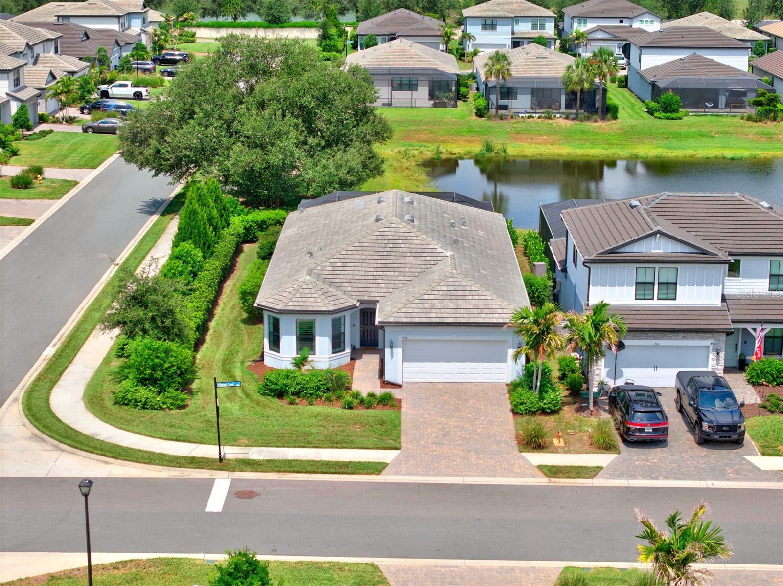 Built in 2023 by Pulte Homes, this highly sought after Mystique model on a corner lot is available in Magnolia Ranch! NO CDD and a LOW HOA for a GATED community! This meticulously maintained home features 3 bedrooms and a DEN, an EXTENDED LANAI overlooking a stunning SALTWATER POOL AND SPA complete with a heater, upgraded travertine pool deck, and full pool cage with noseeum screens, creating the perfect private outdoor retreat for year round enjoyment.Inside, you will find elegant tile flooring throughout, 8 foot door frames, recessed lighting, guide lights throughout the home, plantation shutters, and motorized blinds on the sliding glass doors. The open concept floor plan is beautifully enhanced with soft close dovetail cabinetry and drawers, under cabinet lighting, indoor and outdoor range hoods, and designer finishes throughout. The spacious primary suite offers a luxurious oversized walk in shower and large walk in closet, while additional upgrades include acoustic wall panels in the living room and third bedroom plus a fully soundproofed office with added wall insulation and cork filled doors, ideal for working from home. This home was designed with comfort, efficiency, and peace of mind in mind with features including Storm Smart hurricane screens, custom hurricane shutters, UV light added to the AC system, smart light switches, water softener, electrical panel surge protector, EV charging outlet, 30 and 50 amp generator outlets, and transferable builder warranties including Pulte’s 2 year water intrusion warranty and 7 year structural warranty. The extended garage offers added storage with ceiling racks and finished epoxy flooring, while upgraded landscaping completes the curb appeal of this move in ready home. Luxury, functionality, and thoughtful upgrades come together seamlessly in this exceptional residence. This is Florida living at its finest. This home can be sold FURNISHED! 704 Pintail Cove also qualifies for a lender incentive with the seller’s preferred lender.  Ideally located just minutes from I-75, this home offers easy access to top-rated schools, shopping and dining at University Town Center, the vibrant lifestyle of nearby Lakewood Ranch, and the Fort Hamer Park boat ramp.