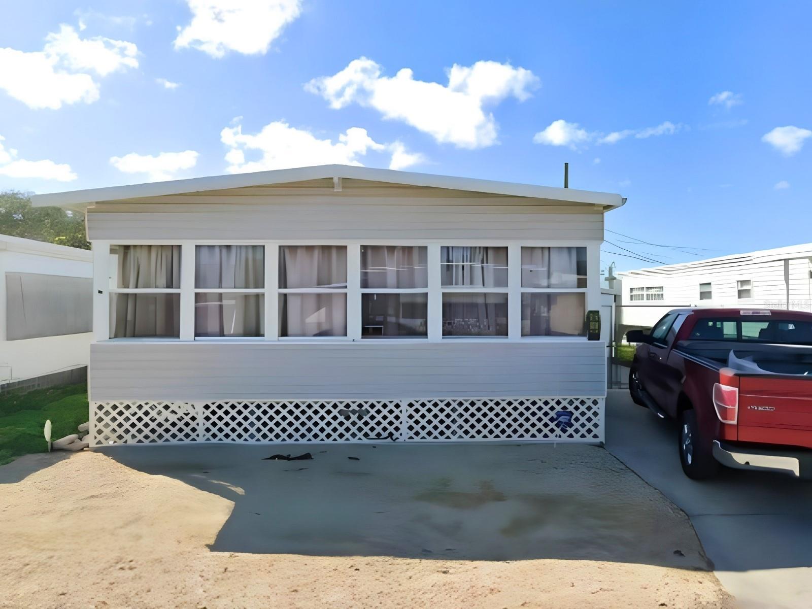 Own the LAND and the home! No Lot Rent, No HOA, No Deed Restrictions! This well maintained, double-wide home sits in a Great Location in West Bradenton! Offering 2 fully furnished bedrooms, one spacious bathroom, plus a half bath in the master room. As you step inside the enclosed front lanai you will enjoy the natural light that fills this bonus space, being cooled off by the AC window unit that is already installed. Relax on the soft, comfy couch that is included in this spacious living room; with built in shelves adding convenience for your decor. The dining room table fits perfectly in this kitchen that includes the dishwasher, range and refrigerator. An add-on laundry room adjacent to the master room includes your washer, dryer, water heater plus room to spare for additional storage. A 125-amp subpanel adds peace of mind, and the open layout makes this home comfortable for year-round or seasonal living. Outside, you'll find a fenced backyard secured by a closing chain-link gate, a storage shed for your tools, and a tandem driveway with a carport. Enjoy this quiet pocket community off Cortez rd in Bradenton but also being minutes away from many restaurants, shops, grocery stores, medical facilities, great schools and more at your reach! The beautiful gulf beaches is just a short drive on Anna Maria Island  and the SRQ airport is right down the road. The home is easily accessible to Sarasota/Siesta Key, Tampa/St.Pete, and Central Florida. Be in the Center of it All with this property! Call today to schedule your private showing.