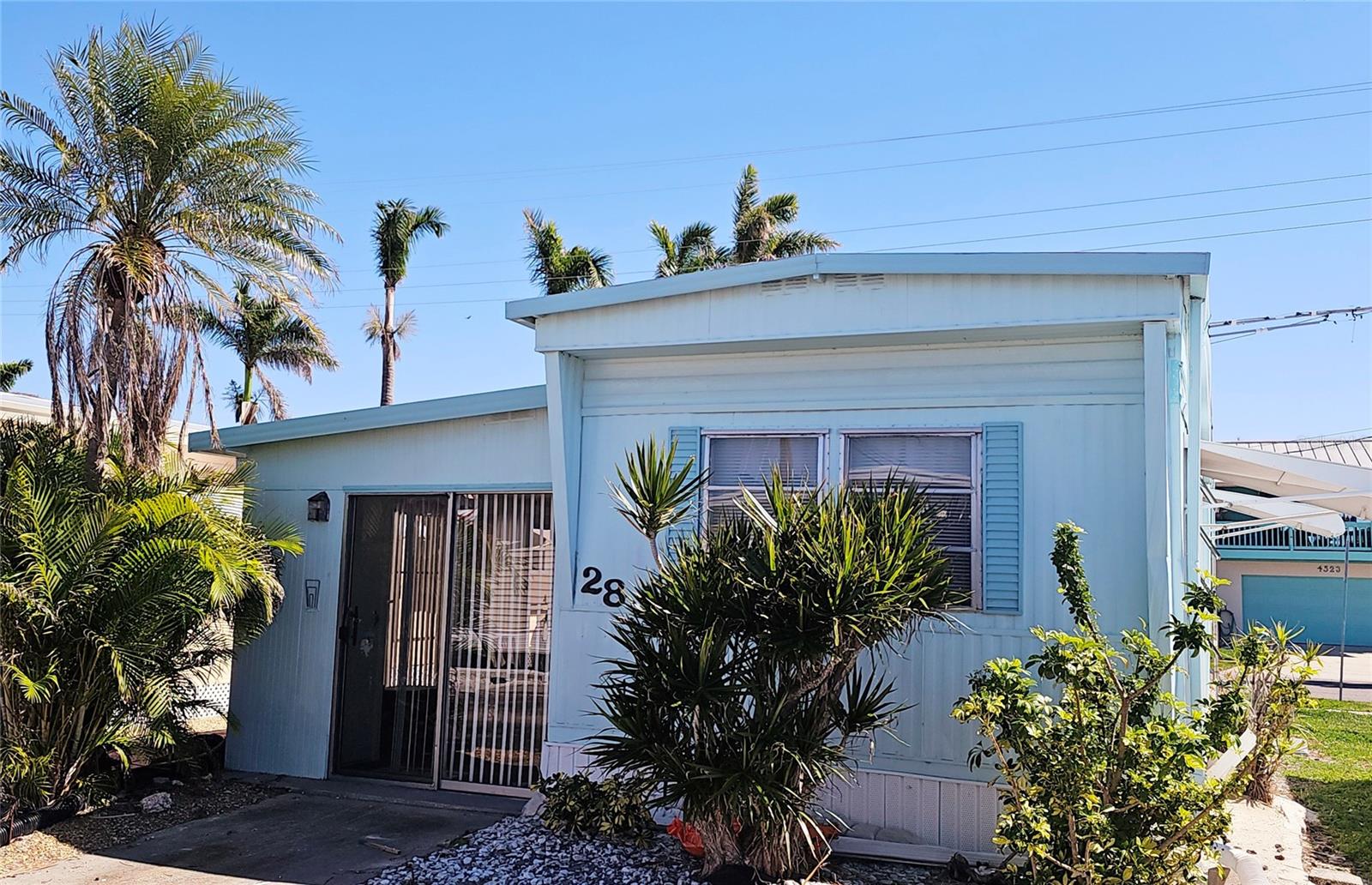 Welcome to Paradise Bay Estates! Seller is offering a fantastic incentive — Owner will pay the first year of maintenance fees with a full-price offer closing by April 30.

This charming 1BR/1BA home is located in a highly desirable 55+ waterfront community just 2 miles from Anna Maria Island and the Gulf beaches. Move-in ready and being sold furnished, this home was refreshed following the 2024 hurricanes and features a new split-system A/C installed in December 2024.

The spacious primary bedroom is currently arranged with twin beds that can easily convert to a king if preferred. A one-car carport offers convenient rear access from 103rd Street, and two storage sheds provide ample space for beach gear, bikes, and tools. The attached shed includes washer and dryer hookups for added convenience.

Paradise Bay Estates is known for its vibrant, active lifestyle featuring a heated pool and hot tub, pickleball courts, potlucks, musical performances, golf outings, community lunches, and the beloved “Music by the Bay” events. The park’s prime Sarasota Bay frontage offers charming waterfront gazebos, abundant Florida wildlife, and breathtaking sunsets over Longboat Key and Anna Maria Island.

Affordable coastal living in an amenity-rich community — come enjoy the Paradise Bay lifestyle!