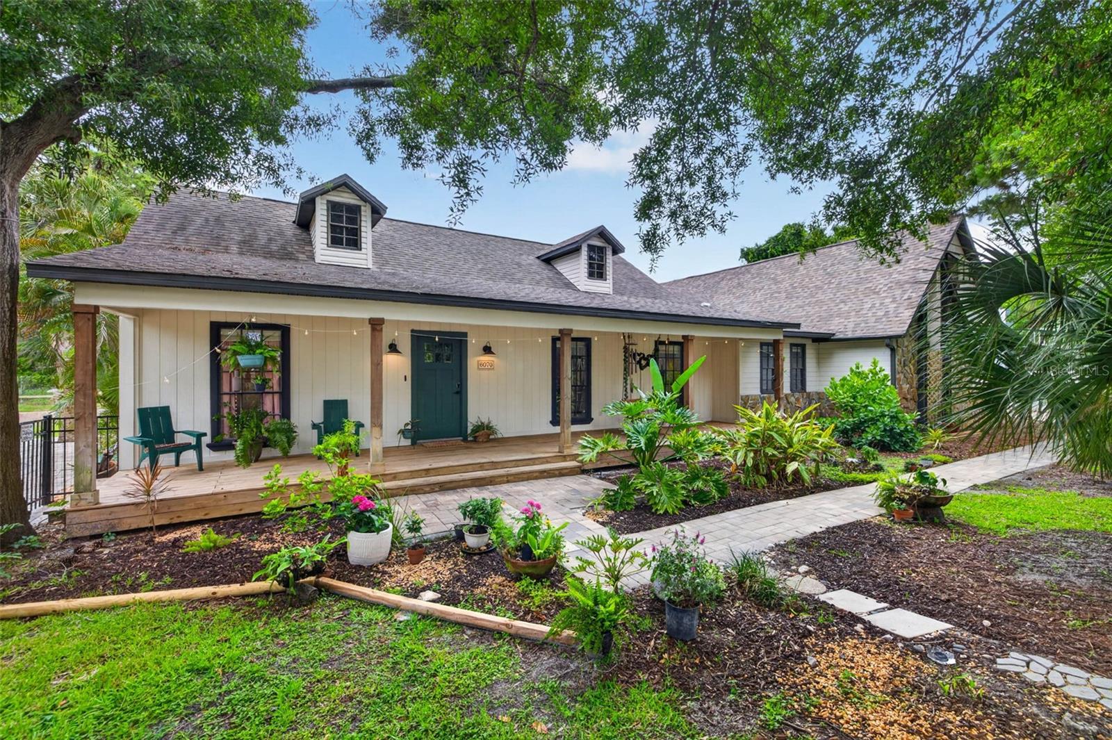 Under contract-accepting backup offers. Sip your morning coffee on your front porch swing and let your troubles melt away! Welcome home -- to a property that offers space, privacy, flexibility, and room for all your toys! Nestled on nearly three-quarters of an acre in the heart of Pinellas County, this renovated 4 bedroom, + 2 offices, 3.5-bath farmhouse feels like a private country retreat while being just minutes from St. Pete's vibrant downtown, shopping, dining, and the Gulf Coast's award-winning beaches. With no HOA, you'll enjoy the freedom to bring your RV, boat, trailers, and recreational vehicles, with dedicated RV hookup and plenty of parking.
The home has been thoughtfully updated and features high ceilings, spacious living areas, and a warm wood-burning fireplace that creates the perfect gathering space. Outside, the lifestyle really shines. Spend your days relaxing by the sparkling in-ground pool with its new paver deck, unwinding in the hot tub, or entertaining friends and family on the screened patio. Meandering garden paths, mature landscaping, and a fully fenced yard create a peaceful setting that feels worlds away from the city, yet everything you need is close by.
One of the most unique features of this property is the incredible garage and workshop spaces. In addition to the ATTACHED 4-car garage, there is a SEPARATE air-conditioned 4-car garage/workshop with its own bathroom and soaring ceilings, making it ideal for car enthusiasts, hobbyists, contractors, small business owners, RV storage, boat storage, or anyone needing substantial workspace. The expansive property also offers room for chickens, goats, gardening, and other hobby farm activities. Already set up with animal pens and fenced yard!
Properties offering this combination of acreage, privacy, updated living space, a resort-style pool, RV and boat parking, multiple garages, workshop space, and a prime Pinellas County location rarely come available. This is more than just a home—it's an opportunity to enjoy the lifestyle you've been looking for. Schedule your tour today!