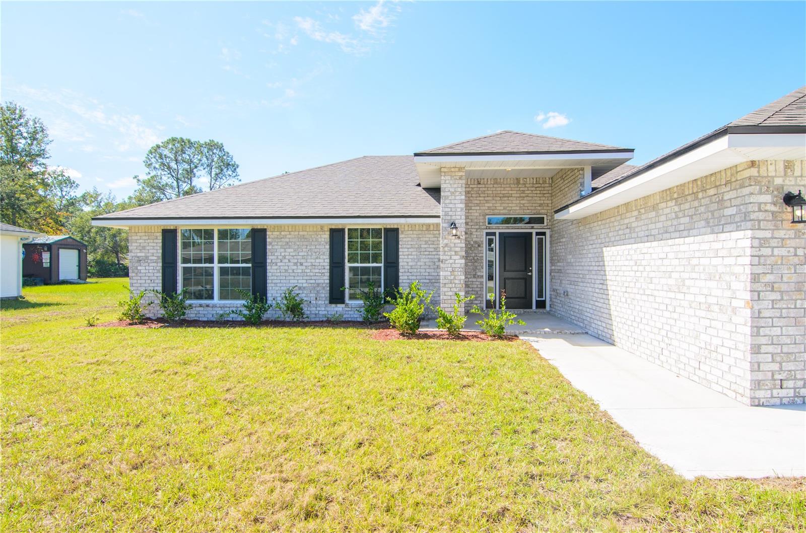Under Construction. Welcome to your brand new dream home in beautiful Palm Coast. With NO HOA or CDD, this thoughtfully designed REAL BRICK 1755 floor plan offers the perfect blend of comfort, functionality, and modern style. Boasting 4 spacious bedrooms, 2 full bathrooms, and 1,760 square feet of living space, this home is ideal for anyone looking to enjoy Florida living at its finest. Step inside to discover an inviting layout with a seamless flow between the living, dining, and kitchen areas—perfect for entertaining or everyday living. The modern kitchen features sleek Quartz countertops and plenty of cabinet space, opening to the family room that leads out to the backyard and patio. The private owner’s suite offers a peaceful retreat with a walk-in closet and en-suite bath featuring dual vanities and a five foot shower stall with glass door. Three additional bedrooms provide ample space for guests, a home office, or hobbies. Situated in the Lehigh Woods "R" Section in Palm Coast, you’ll enjoy no HOA or CDD fees and close proximity to local parks, beaches, shopping, dining, and schools. With quality construction and builder’s warranty, you can buy with confidence. Whether you’re looking for your first home, a forever home, or a vacation escape, the 1755 plan is a must-see! Schedule your showing today and experience Florida living! Only $1,000 deposit required & MOST CLOSING COSTS PAID WHEN USING AN APPROVED LENDER, SAVING BUYERS THOUSANDS OF DOLLARS!! **Photos are not of actual home and are for illustration purposes only. Finishes/colors may vary from photos**