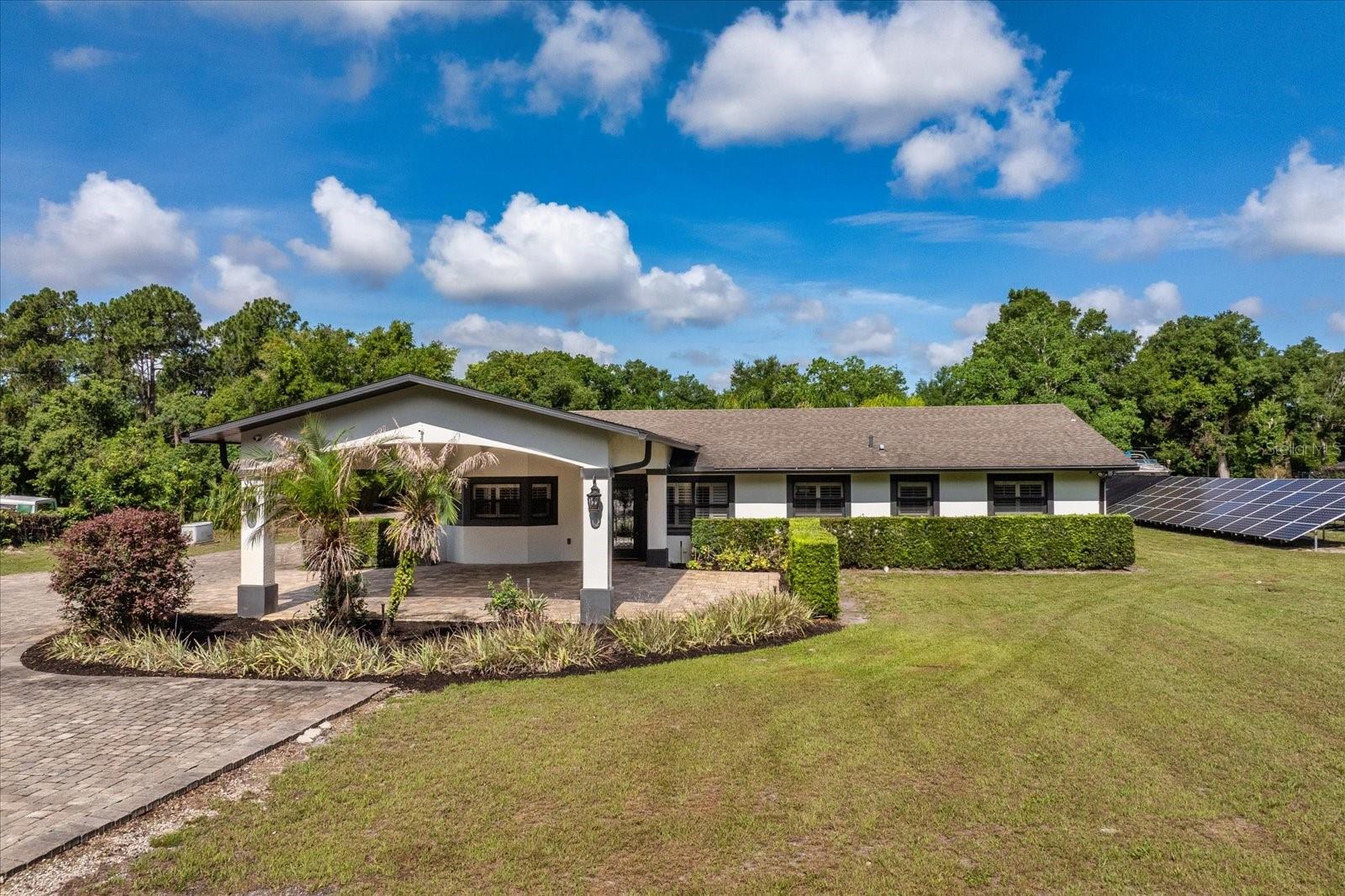 WELCOME TO ONE OF ALTAMONTE SPRINGS' MOST UNIQUE PRIVATE ESTATES. Hidden behind a private automatic gate and nestled on nearly two fenced acres, this extraordinary estate offers a rare blend of luxury, privacy, flexibility, and resort-style living—just minutes from everything Central Florida has to offer. Designed for those who need more than a traditional home, this property delivers an unmatched lifestyle with a beautifully appointed 3 bedroom, 3 bath main residence, an incredible detached 3,200-square-foot workshop with 2 bedroom, 1 bath In-law/guest suite, and outdoor amenities that rival a private resort. Inside the main residence, elegant finishes and thoughtful craftsmanship are showcased throughout. Imported Italian granite, custom millwork, crown molding, plantation shutters, and integrated smart-home technology create an atmosphere of sophistication and comfort. The chef's kitchen serves as the centerpiece of the home, featuring stainless steel appliances, gas cooking, double convection ovens, a wine refrigerator, abundant custom cabinetry, and an oversized gathering island designed for entertaining. The living spaces flow effortlessly into a spectacular Florida room overlooking the estate's show-stopping outdoor retreat. Step outside and discover your own private resort. The fully automated saltwater pool features an oversized sun shelf, mesmerizing fiber-optic lighting, dramatic fire bowls, deck jets, and integrated surround sound. The outdoor summer kitchen is equally impressive, complete with a granite serving bar, built-in grill, refrigerator, sink, and television hookups—creating the ultimate setting for unforgettable gatherings year-round. What truly sets this property apart is its incredible 3,200-square-foot workshop and flex space. Whether you're a car collector, entrepreneur, hobbyist, fitness enthusiast, or seeking multigenerational living options, this remarkable structure provides endless possibilities. Complete with guest accommodations including two bedrooms, a full bath, gym space, and a large walk-in closet, it offers flexibility rarely found in today's market. Additional highlights include a whole-house generator, extensive parking for boats, RVs, trailers, and recreational vehicles, covered parking, dedicated security systems, and ample room to expand or customize to fit your vision. Properties offering this level of privacy, functionality, and luxury are exceptionally rare. This is more than a home—it's an oasis designed for those who want space to live, work, entertain, and enjoy life without compromise. Schedule your private tour today and experience one of Altamonte Springs' most exceptional estate properties. Note: The lift in the workshop does not convey.