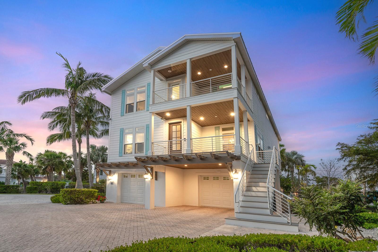 Price improvement! Discover your coastal retreat in the heart of Siesta Key, where lush gardens create a relaxing oasis near the Gulf. This stunning four-bedroom, three-and-a-half-bath coastal contemporary home offers a blend of luxury and convenience, perfect for full-time living or as your ideal vacation residence. Just .2 miles from the pristine, powdery white sands of Siesta Beach and only a half mile from the charming shops and restaurants of Siesta Village, this home offers an unbeatable location. With everything you need nearby, you can park your car and unwind in paradise. The moment you step inside, you are greeted by a color palette inspired by the sea and nature, creating a bright and welcoming atmosphere. The open-concept floor plan features a great room with built-in cabinetry and fireplace, a dining area, and a chef’s kitchen and breakfast bar, which boasts custom cabinetry, quartz countertops and a suite of GE Café appliances, including a smart 5-in-1 oven, wall convection oven and a five-burner range with a pot filler. New pendant lighting and dining chandelier add to the inviting feel. The new, custom-designed bar room is the perfect place to gather and enjoy a cup of coffee in the morning with the new Miele coffee system, as well as watch sporting events with family and friends. Entertaining will be a pleasure with the two Uline wine refrigerators and freezer drawer. A private balcony overlooks the pool, with direct access to the expansive backyard via a curved staircase. A bedroom on the main floor doubles as a second primary suite, offering a luxurious en-suite bath, complete with stone countertops, custom cabinetry, glass subway tiles, and river stone floors—a convenient half bath rounds out the main level. Upstairs, the home offers even more space with a bonus room equipped with a mini kitchen and a west-facing balcony for those unforgettable, mango and fuchsia Siesta Key sunsets. The primary suite includes a private balcony overlooking the pool, while two additional guest bedrooms and a shared bath complete the upper level. Throughout the home, you'll find high-quality touches, including crown molding, transom windows, tray ceilings, and wide-plank wood and bamboo flooring. Go outside and discover the gem of this home, the professionally landscaped gardens. Tropical and lush, the private oasis offers ample space to sunbathe, swim in the large freeform saltwater pool, or relax under covered areas designed for entertaining, dining, and lounging. After a day at the beach, the outdoor shower will quickly become a favorite. In the evenings, gather around the fire pit to stargaze or unwind with family and friends. This home also boasts numerous upgraded amenities, including a new three-floor elevator from the garage, metal roof (2023), Lennox five-ton HVAC (2024), fresh exterior paint, wood balcony ceilings, garage doors (2022), newly renovated great room and bar room with custom built-ins, a whole-house gas generator, irrigation well and eco-friendly faux turf. With Hardie board siding, a paver driveway, and extensive landscape lighting, this home is both functional and beautiful. Ideally located on Siesta Key, close to Out-of-Door Academy and only 15 minutes from downtown Sarasota’s vibrant shopping, dining, and cultural attractions, this home is move-in ready. Don’t miss out on the opportunity to own a piece of paradise; your dream home awaits!