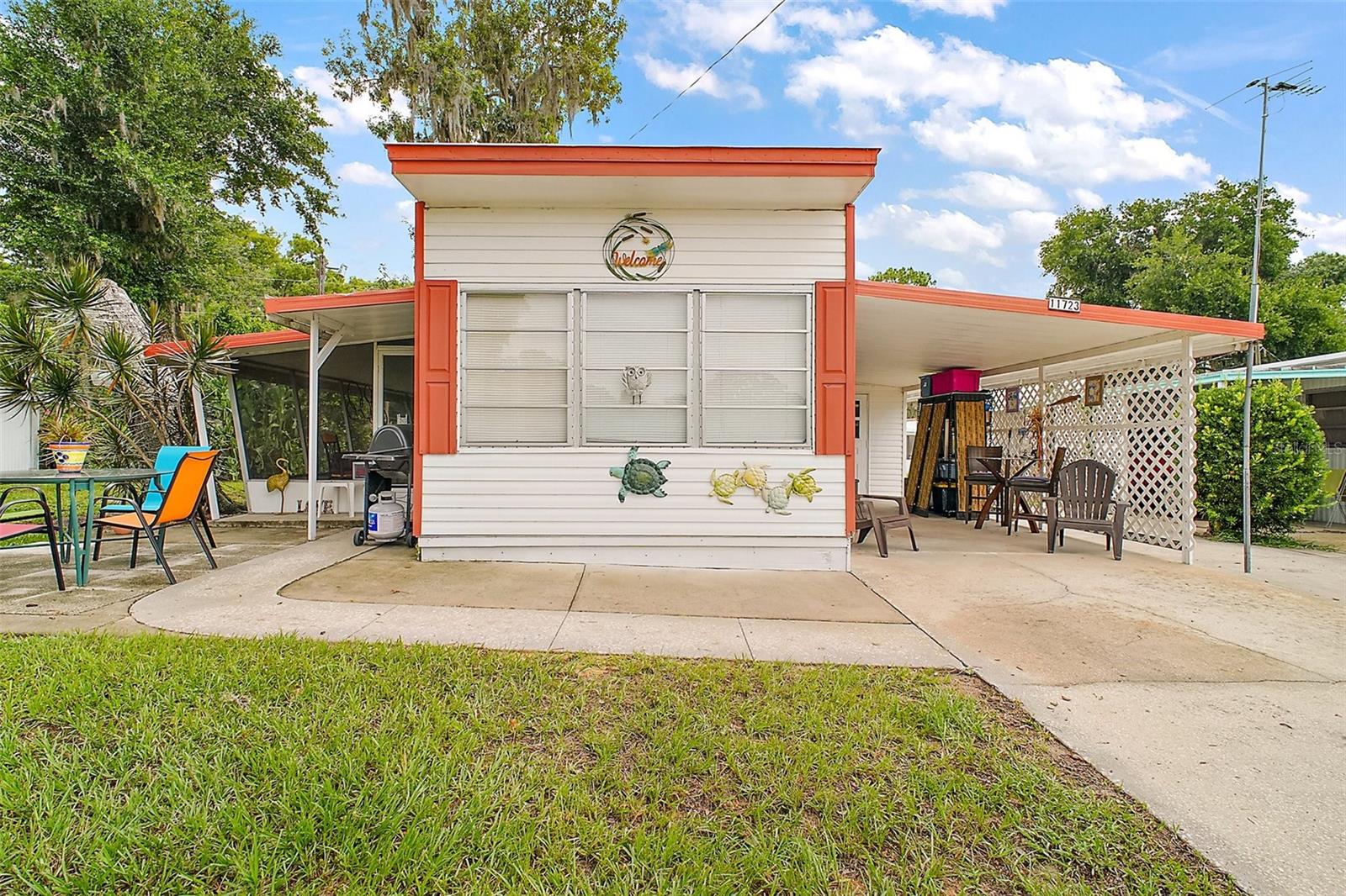 Nestled in the highly sought after 55+ community of IMPERIAL TERRACE WEST in Tavares, this charming and cozy 2-bedroom, 2-bath home offers peaceful living in a serene setting.  The home features an open-concept kitchen and living area beneath an 8-FT HIGH CEILING and is equipped with essential appliances - including a REFRIGERATOR, a newer DISHWASHER (11/24), and an ELECTRIC STOVE.  Comfort is ensured year-round with MINI SPLIT SYSTEMS (05/23) that efficiently heat and cool the entire home.  The ROOF has been sealed (05/25).  Two FULL BATHS, one with a TUB and the other with a WALK-IN SHOWER, give privacy to each bedroom.  The carport and extended driveway have room for three vehicles and a golf cart.  Surrounded by mature trees and lush greenery, the exterior feels like a peaceful retreat.  A spacious screened in FLORIDA ROOM offers shaded relaxation throughout the day, while a large exterior SHED/WORKSHOP adds excellent storage and workspace.  This home comes unfurnished.  IMPERIAL TERRACE WEST offers a wide range of amenities: GOLF-CART friendly community, CLUBHOUSE for social events, INDOOR POOL, JACUZZI/HOT TUB, and a LIBRARY.  There is also a MARINA with RENTABLE BOAT SLIPS and optional STORAGE FOR BOAT TRAILERS or ENCLOSED STORAGE TRAILERS, adjacent to a large scenic nature preserve.  With a low HOA of $25/month and the benefit that "YOU OWN YOUR OWN LAND", this home presents an exceptional opportunity for comfortable and affordable living.  Schedule your tour today and discover your new home!!
