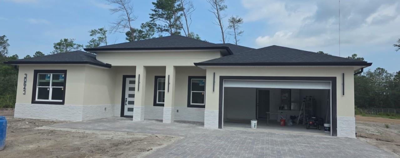 Under Construction. Home is currently under construction and nearing completion. Brand-new construction situated on a spacious 1-acre lot in the desirable Royal Trails community of Eustis! This stunning 4-bedroom, 3-bathroom home plus a private office offers living space with an open and modern design perfect for everyday living and entertaining. Features include gorgeous porcelain wood-look Porcelain tile throughout, elegant wood cabinetry, quartz countertops, and beautifully finished bathrooms with floor-to-ceiling porcelain tile, marble decorative mosaics, and glass shower enclosures. The kitchen comes fully equipped with stainless steel appliances. Enjoy outdoor living with a custom summer kitchen featuring a built-in grill, sink, and refrigerator. Additional upgrades include paver driveway and front entry porch, covered rear lanai, and quality finishes throughout. Zoned to allow up to 2 horses p e r acre and offering low HOA fees of only $92 annually, this property combines luxury living with the freedom and space of country-style living while still being conveniently located near Downtown Eustis, Mount Dora, shopping, dining, parks, and outdoor recreation. Enjoy easy access to the Harris Chain of Lakes, boating, fishing, hiking trails, and nearby nature preserves including Ferran Park and Palmetto Point Park. Just a short drive to charming Downtown Mount Dora with its restaurants, boutiques, festivals, and waterfront attractions. Convenient shopping options include Eustis Village and Mount Dora Marketplace. * Listing agent has interest in property.*