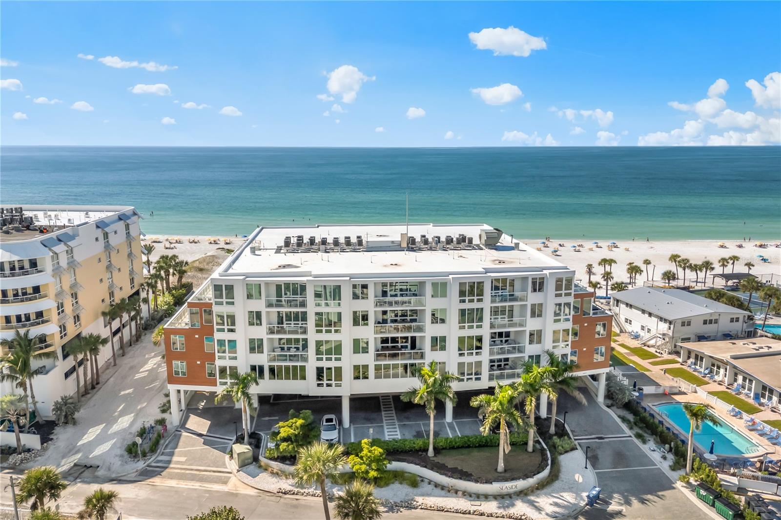 Experience beachfront ownership that works for you. Residence 404 at Ten35 Seaside offers a rare opportunity to own a fully operational, income-producing property on Siesta Key’s Crescent Beach — one of the most sought-after vacation rental destinations in Florida.
This residence is enrolled in the community’s on-site professional rental management program and is already completely booked for the current season, providing immediate revenue and eliminating the uncertainty, setup time, and operational burden typical of vacation rental ownership. Owners benefit from a true turnkey investment: marketing, guest services, housekeeping, and day-to-day management are handled on-site, allowing you to generate income while still reserving personal use.

Inside, the unit is designed specifically for both durability and guest appeal. Floor-to-ceiling hurricane-rated glass fills the open living space with natural light, while porcelain wood-look flooring, custom finishes, and curated furnishings create the upscale coastal experience today’s renters actively seek and review highly. The kitchen features quartz countertops and premium Wolf appliances, opening seamlessly to the living area — ideal for group stays and longer bookings.

The flexible floor plan maximizes occupancy potential, with a spacious primary suite, guest bedroom, and an integrated Italian fold-down bed system that expands sleeping capacity without sacrificing aesthetics — an important driver of rental performance.

The private covered lanai captures panoramic Gulf views, a major booking advantage and one of the most requested amenities among Siesta Key vacationers.

Ten35 Seaside functions as a boutique resort for guests and owners alike, offering:
• Direct beach access to Crescent Beach
• Gulf-front pool and spa
• Private cabanas
• Fitness center
• Fire pit and gathering areas
• Daily beach chair and umbrella service

Rental parameters allow one-week minimum stays in the off-season and two-week minimums during peak season, striking an ideal balance between revenue generation and property preservation.

Located moments from Siesta Key’s South Village dining and shopping, the property consistently attracts repeat visitors — a key factor in maintaining strong occupancy.

Whether you are expanding a portfolio, completing a 1031 exchange, or seeking a vacation home that offsets ownership costs, Unit 404 offers a combination rarely found on Siesta Key: Gulf-front location, professional management, and immediate rental income from day one.