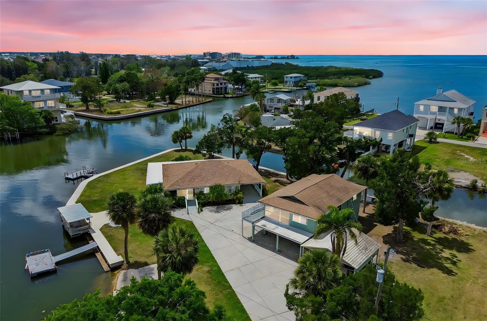 One or more photo(s) has been virtually staged. • General description tour presents 2 homes elevated above average ground level. 2.5 lots with a 3rd lot attached (3.5 lots total), surrounded by 520 ft (mol) waterfront.  The 3rd lot 60 X 110 buildable site w/60 feet on canal. Lot adjoins main property.  Both homes have new HVAC systems w/10 years transferrable warranties. Homes are turnkey & move in ready.    

• The waterfront is a large spring feed/tidal bay & canal with Gulf view & access, bordered by an extensive retrofitted 420 (mol) 2023 seawall with massive bulkhead & a 4 ft wide concrete cap/sidewalk permitting great sightseeing & fishing areas.

• Main home is 3 bdrm, 2 bath, large kitchen with many cabinets and much counter tops, adjacent to laundry utility, great dining area, family and living rooms.  A nice foyer patio room at the entrance with a wraparound waterside covered porch with real usable & livable space. The site extends to outside living to a large patio area & a front row seat to the activities on the bay.                                                                         See floor plan in pictures for sizes and configuration (picture 98 of 98).
Kitchen with new LG Wi Fi appliances Refrigerator, Range, Microwave & Dishwasher.  Home’s hot water is provided by a new 50-gal high efficiency hot water heater.  Many upgrades and modernization promoted in the home.
• Second home is an upstairs home over a large garage with 2 16ft garage doors, with home having 2 bdrm. 1 bath, offering an efficient kitchen, dining area, livrm & a great screen enclosed entry porch with great views & entertaining.  Additionally, there are porches & decks on the exterior.
See floor plan in Pictures for sizes and configuration (picture 98 of 98).

• The grounds are unique with an old Florida park-like atmosphere hosting a number of outside amenities such as; 2 boat ramps, 2 floating docks, a fixed covered dock, firepit, outside patio areas, driveways and multiple parking including a stand-alone double carport. 

• The property exhibits an old Florida park like atmosphere.  Only minutes from shopping and medical, including hospital, many restaurants, plus logistically in reasonable travel distance to major places and events such as;  Disney World, Universal, SeaWorld and other theme parks less than 2 hours, other places less than an hour, Raymond James home to the TB Bucs/Football, Tropicana home of the TB Devil Rays/Baseball, TB lightning/Hockey,  the famous Clearwater Beach to mention a few with Tampa and St Petersburg for the Arts.  Also need to note events obvious, immediate fishing and boating, Sun West Park, Great swimming with many activity features, of course cannot forget Weeki Wachee, the home of the Mermaids, waterways and parks.  Certainly not last or least, Hudson beach while small and quaint offering some of the best sunsets in the area.  The area is Golf Cart friendly. A ride to the beach, watch the sunset close the day, stop for dinner or libation at one of the restaurants or maybe the Ice Cream shop.   The exciting part with all this and at the same time the property provides near exclusive privacy and seclusion.

• Seller’s notes:  While the photos are generally nice the full charm and quality for this property cannot be appreciated near to an onsite personal presence.  Transferrable insurance savings.   Tkyou
Realtor's welcome. 

Disclaimer: For exact dimensions of properties, and info review public records. Some photos have been virtually rendered.