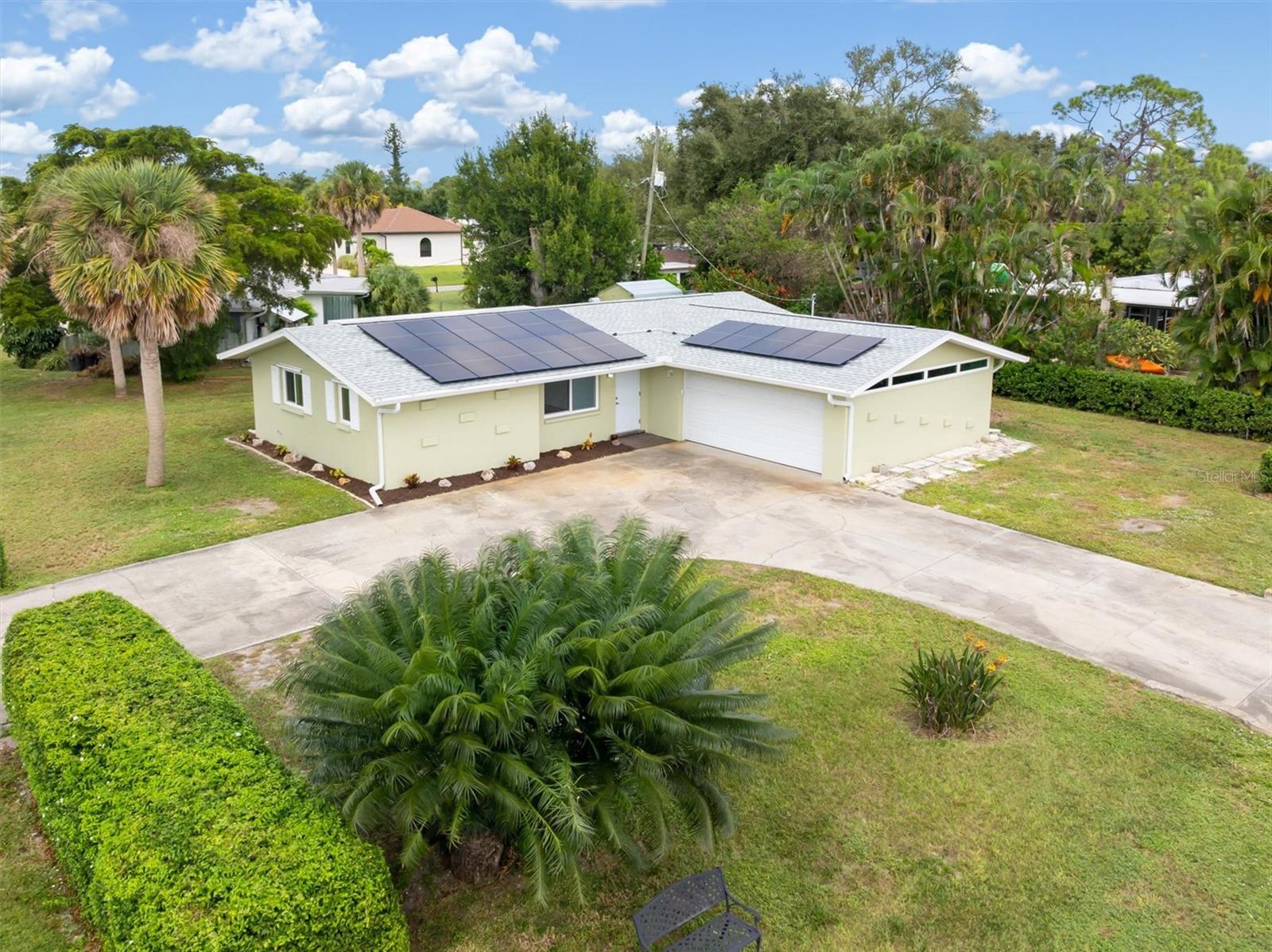 Virtually Staged. Welcome to this updated 2-bedroom, 2-bath home with a 2-car garage located on a corner lot in South Venice, surrounded by mature palms and tropical landscaping. No HOA, no CDD fees, and located in an X flood zone.

Seller will pay off the solar system at closing, allowing the next owner to benefit from low electric costs without assuming a solar loan.

Major improvements have already been completed, including a new roof (2022), HVAC (2022), hurricane-impact windows (2021), water heater (2024), and solar panels installed in 2022, contributing to an average electric bill of approximately $45 per month.

Inside, the home features a freshly painted interior in soft coastal tones and new flooring throughout. The kitchen has been updated with quartz countertops, stainless-steel appliances, soft-close cabinetry, and modern finishes, opening to a bright living space suitable for both everyday living and entertaining.

The primary bedroom includes a walk-in closet and private en-suite bathroom, while the guest bedroom and second full bathroom provide flexible space for visitors, a home office, or additional living needs. Updated lighting and modern outlets with built-in safety features are found throughout the home.

The screened lanai offers a comfortable outdoor space with shade and privacy from mature trees. A detached storage shed provides additional storage for tools, beach gear, or hobby items.

Located approximately one mile from optional access to the South Venice Beach Ferry and private boat ramp, and just minutes from Manasota Key Beach, Venice Beach, Downtown Venice, parks, trails, and nearby kayak launches.

Some photos have been virtually staged to illustrate potential room layout and design.

Schedule your private showing today!  SELLERS WILL REVIEW ALL REASONABLE OFFERS!