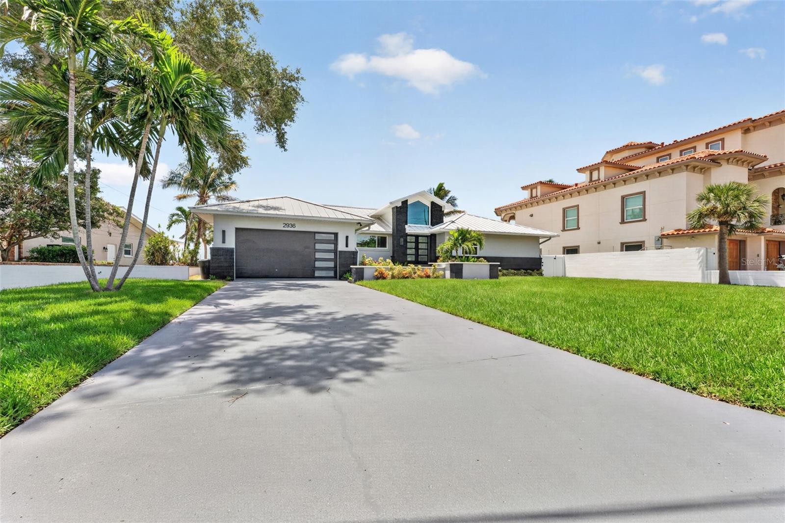 Nearly every inch of this exceptional waterfront home has been beautifully remodeled within the last six months, offering a truly move-in-ready opportunity on a private, oversized lot of more than one-third acre. Enjoy breathtaking water views & spectacular vistas of the iconic Sunshine Skyway Bridge from your own backyard, creating a stunning backdrop for everyday living. Built on a raised 4-foot stem wall, this home has never flooded, providing exceptional peace of mind while allowing you to enjoy waterfront living with confidence. From the moment you arrive, you'll appreciate the home's striking curb appeal, enhanced by fresh professional landscaping, a new irrigation system installed in 2025, modern double entry doors, and matching garage doors that create a stunning first impression. Step inside to an oversized foyer that opens to a thoughtfully redesigned interior filled with natural light, thanks to an abundance of impact-resistant windows & doors that showcase the surrounding water views while maintaining privacy. Fresh interior & exterior paint, new luxury vinyl plank flooring, solid-core interior doors, designer trim, and matte black hardware come together to create a clean, contemporary feel throughout the home. The show-stopping kitchen is designed for both everyday living and entertaining, featuring an oversized island topped with Level 5 granite and a dramatic waterfall edge. Perimeter countertops are finished in elegant white quartz with warm veining, accented by a black granite composite sink, matte black backsplash tile & designer black faucet. Brand new refrigerator with craft ice maker. Natural gas range provides the perfect setup for those who enjoy cooking, while a custom pantry & custom closet systems throughout the home by Closets By Design provide exceptional organization & storage. The newly designed laundry suite offers both convenience & functionality with a utility sink, new washer and dryer, and abundant built-in cabinetry. The luxurious primary suite continues the home's upscale design with striking muted blue dual vanities offering generous storage, oversized mirrors, and a spa-inspired walk-in shower featuring seamless glass enclosure with dual shower areas. Additional interior upgrades include all-new designer lighting, ceiling fans, and plumbing fixtures throughout. Major exterior improvements include a 2020 standing seam metal roof, a paid-in-full solar panel system with battery backup, an EV charging station, and a 2023 natural gas water heater, resulting in an average electric bill of approximately $35 per month. Additional updates include 2019 & 2026 A/C systems, a new 2025 composite dock, a 2016 seawall and cap, a professionally stained and sealed driveway completed in 2026, freshly cleaned & sealed pool pavers, and a beautifully resurfaced Pebble Tec pool with a gas-heated spillover spa. Every window & exterior door has been upgraded to hurricane, impact-resistant construction for added security, efficiency, and peace of mind. The current flood insurance policy is assumable at approximately $3,000 per year, adding even more value and affordability for the next owner. With luxury finishes, extensive recent renovations, remarkable waterfront views, outstanding energy efficiency, and virtually nothing left to do, this one-of-a-kind property offers the perfect blend of modern elegance and Florida waterfront living. Check out the option for a 3 full bath that is already plumbed - just needs your touch.