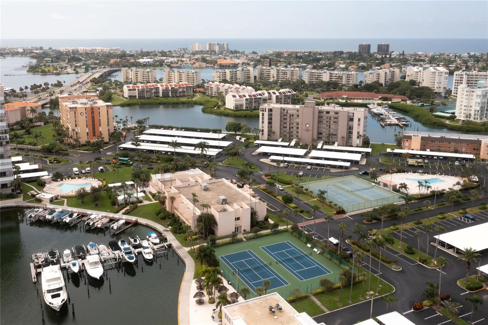 Welcome to Bay Island — a beautifully maintained, guard-gated 55+ waterfront community overlooking the sparkling Boca Ciega Bay. This 3rd-floor unit offers wide-open water views the moment you step inside. Watch dolphins play, boats drift by, and enjoy nightly sunsets from your private balcony.

This spacious 2-bedroom, 2-bath condo is designed for comfort and convenience, featuring an in-unit washer & dryer, a dedicated storage locker, and covered parking just steps from the building entrance.

Bay Island is known for its vibrant, active lifestyle with a full calendar of social events and 24-hour security. Residents enjoy six heated pools, a waterfront tiki hut with BBQ grills, a marina with boat slips available through a sign-up list, and a first-class clubhouse offering pool tables, card rooms, a library with internet access, and separate his & her fitness centers, each with saunas and spas. A scenic 1.25-mile waterfront walking path wraps around the community, perfect for morning walks or evening strolls.

Located just minutes from St. Pete Beach, restaurants, shopping, and vibrant downtown St. Petersburg — with quick access to Tampa — this community truly has it all. Enjoy resort-style living with unmatched amenities in one of the area’s most desirable 55+ waterfront communities.