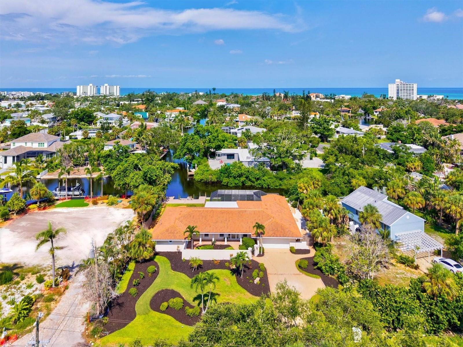 Virtually Staged. Discover this FULLY RENOVATED four-bedroom, three-bathroom sanctuary spanning 3,541 square feet, where luxury living meets WATERFRONT tranquility. Situated on almost a half acre lot, with rear views facing west for colorful sunsets, this meticulously crafted residence boasts a heated pool, a floating dock and long seawall inviting water enthusiasts to enjoy exploring the canals which lead out to the open waters of Sarasota Bay.

 The heart of this distinguished home features an expansive open-concept main living area, chef's kitchen and spacious dining space, thoughtfully designed to accommodate family and guests while offering sweeping views of the sparkling pool and canal. The seamless flow of the layout and blending of the outdoor and indoor space creates an entertainer's paradise, perfect for culinary adventures and memorable gatherings.

Retreat to the luxurious primary bedroom, where panoramic canal vistas provide a serene backdrop for morning coffee or evening reflection. Unwind in the spa-like bathroom featuring a soaking tub, walk-in shower, dual vanities and frosted sliding glass doors to the outdoor shower. The SPLIT FLOORPLAN ensures ease and privacy for all. Bedroom 2 features an en-suite bathroom and long water views! Bedroom 3 has double doors and can be utilized as a den or office space if desired. Bedroom 4 has a private entrance with sliding glass doors overlooking the sunny front courtyard. This thoughtful layout offers many options for use of the generous space.

The coral stone tiled pool and lanai area transforms into your personal oasis, where gentle breezes dance across the water's surface, creating an atmosphere of pure indulgence after sun-soaked beach days. The fully fenced yard, greenspace, winding walkways, outdoor shower, 2 car garage with extended driveway and parking space complete this comfortable retreat. 

The property's exceptional LOCATION places you moments (just .6mi) to the vibrant Siesta Village, where boutiques and acclaimed dining establishments await your discovery. (Just .7mi) to the nearest beach access! The main entrance to World-renowned Siesta Beach, celebrated for its powdery white sands and crystal-clear waters, beckons just over a mile away. This remarkable residence represents more than mere accommodation; it embodies a lifestyle where every detail has been carefully considered.

 From the quality construction evident throughout to the thoughtful integration of indoor and outdoor living spaces, this home promises years of comfort in one of Sarasota's most coveted waterfront communities.