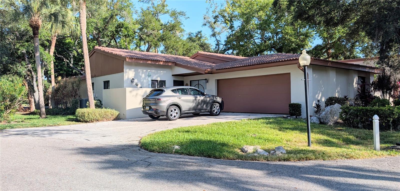 Lovely Mediterranean garden villa in the lovely maintenance free community of Wild Oak Bay. Lush tropical environment near Sarasota Bay features a very pleasant walking and bicycling neighborhood. Spacious kitchen open concept, and it opens up to the spacious dining and living room with expansive volume ceilings, making the already large room look even larger. The third bedroom can be used for an office or a family room, it features a wet bar with additional storage which can be converted back to a closet if needed. The spacious master bedroom has a large walk-in closet and a wall closet. The bathroom has a separate shower/toilet room for privacy. The second bedroom has a set of sliding doors that opens up to the front patio. The 2-car garage offers over 600 square feet and has a newer hurricane door. Just down the road from the IMG Golf and Country Club where you can enjoy socializing and dining, there is also a gym if you are interested. Close to shopping, SRQ Airport, fine dining, theaters, museums, farmers markets and so much more. Florida's award winning West Coast Beaches are a short drive away where you will find Anna Maria Island and Siesta Key is a bit further to the South.
