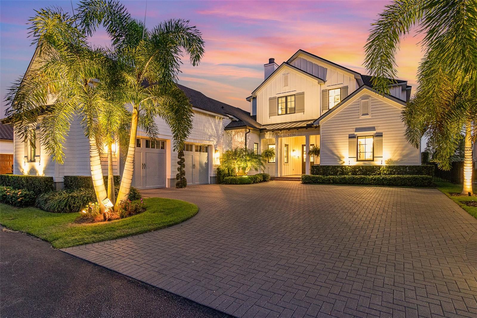Welcome to luxury, lakeview living in Baldwin Park, where this hidden GEM awaits! Built in 2020, this waterfront masterpiece offers breathtaking lake views, unparalleled craftsmanship, and a fabulous, functional floorplan. The $125K+ in recent updates further elevate this home, including custom exterior lighting, an electric car charging port, additional landscape and hardscape, a 2nd laundry upstairs, AC unit in the garage, surround sound, whole-house water purification system, custom window treatments, and more!
Embrace the serenity, overlooking Lake Susannah and the adjacent mews/park, from the home’s outdoor oasis. Designed for optimal entertainment or relaxation, the 2 living/dining areas are wrapped in motorized phantom screens, with a gas fireplace, a complete summer kitchen, and a saltwater pool with a sun shelf, fountain, and LED lighting. The outdoor area and expansive travertine paver deck is fully fenced-in, and a block wall across the back, with integrated lighting, adds privacy. 
Step through the inviting front porch to the sunny, open living space with a gas fireplace and custom built-ins. The rear wall is adorned with sliding glass doors, framing views of the outdoor living space, pool, and the serene lake beyond, while a private front-facing office/flex room, with barn doors, provides an ideal workspace.
The expansive kitchen, with the massive quartz island, offers Monogram appliances including a 6-burner gas stove with a griddle, 2 ovens, a full-size refrigerator and freezer (both 36” wide), and a wine refrigerator. Tucked behind the kitchen is a functional scullery/butler’s pantry that is uniquely stocked with a 2nd prep sink, 2nd dishwasher, and a walk-in pantry. 
The 1st floor Primary Suite is a dream, featuring pool and lake views, a luxurious custom closet with an island, and a hidden safe room with endless uses.  A 2nd DOWNSTAIRS en-suite, with a private bathroom, offers convenient space for your guests. 
The main staircase leads to the 2nd floor, with 2 bedrooms, both with en-suite baths, a powder bath off the bonus room, and a 2nd laundry with a washer & dryer. The bonus room with vaulted ceilings is bursting with natural light, and offers custom built-ins with a wet bar and mini- refrigerator, plus a wall of expansive windows for capturing stunning sunrises and sunsets over the lake. 
The 2nd staircase, over the garage, leads up to a private, additional 5th bedroom/game room, complete with an en-suite bathroom and walk-in closet.
The impressive, oversized 2-car garage is equipped with storage cabinets by Garage Tek, indoor/outdoor carpet, and an electric car charging port, while a new mini split AC keeps it cool and comfortable. 
This home is ideally located only 3 blocks from downtown Baldwin Park’s shopping and dining, and only a few miles from the East End market, Winter Park’s Park Ave., and downtown Orlando.  With A-rated schools, this home truly has it all—a perfect blend of luxury, functionality, and serene living!