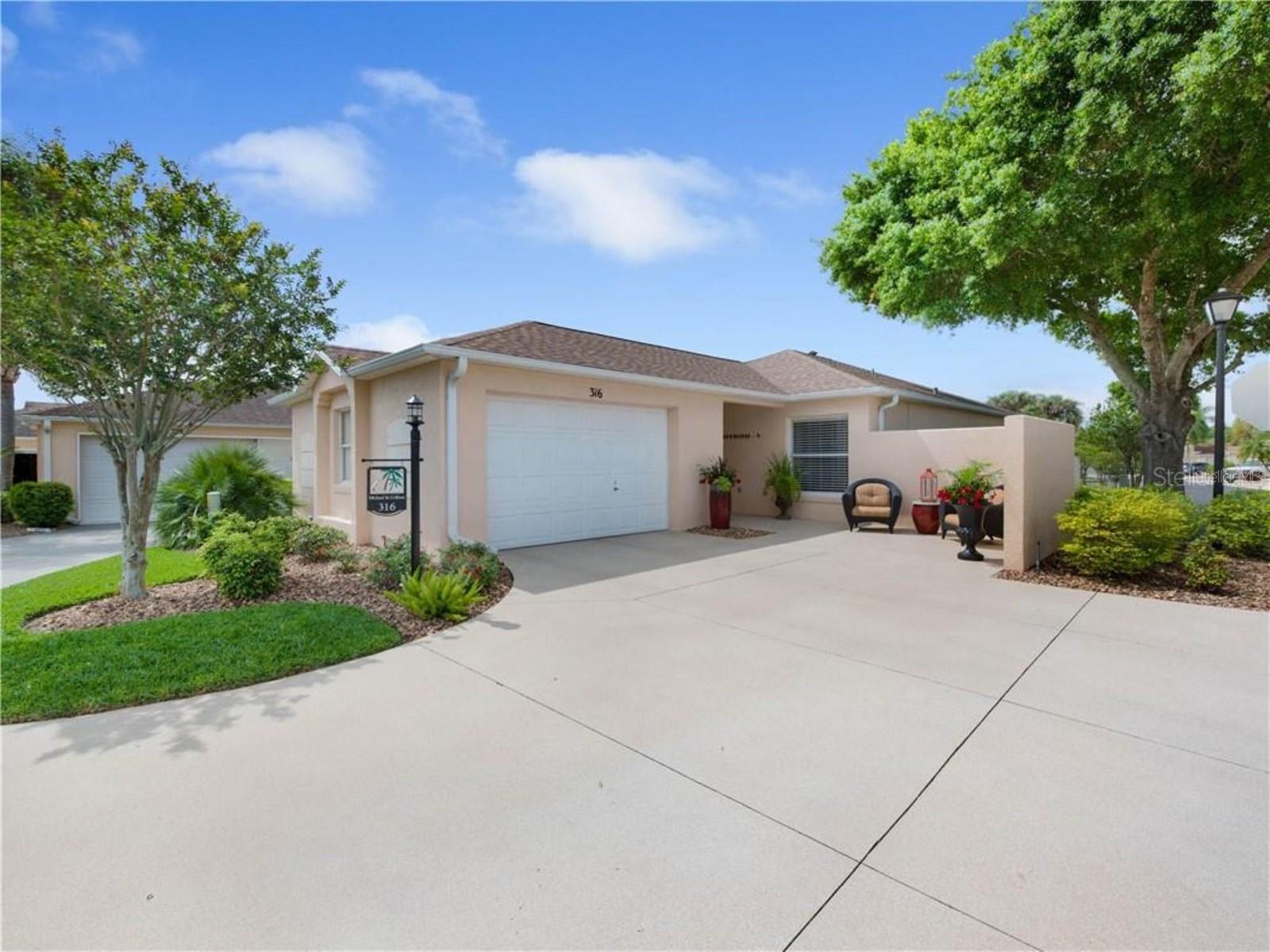 IDEALLY LOCATED near LAKE SUMTER LANDING in VILLAGE of DE LA VISTA SOUTH, this FURNISHED and TURNKEY Courtyard Villa is the perfect long term rental. Situated on a CORNER LOT, this 2/2 BLOCK and STUCCO Villa is COMPLETELY REMODELED with Hand Finished Shiplap Ceilings,Crown Molding, Plantation Shutters, Tile Flooring in main areas, Carpeted Bedrooms, Updated Kitchen and Bathrooms with Soft Close Cabinetry,Granite Countertops, Stainless Appliances and Range Hood, Indoor Laundry, Updated Lighting throughout, 2018 Roof and HVAC. Primary Suite has King bed, WALK IN CLOSET and en suite bath with DOUBLE SINK VANITY and WALK IN SHOWER. Guest room has twin beds, BUILT IN CLOSET and adjacent Guest bath with SINGLE SINK VANITY and WALK IN SHOWER. Laundry is conveniently located next to Guest Bath.Enclosed Lanai offers another sitting area and leads to PRIVATE BACK YARD and patio. There is another patio off the dining area with picnic table, side yard and gate access. Owner provides lawn care, water, sewer, trash & Amenity Fee. Tenant is responsible for electric, cable, internet and typical interior maintenance. First & last month plus security required. Available September 2026.
