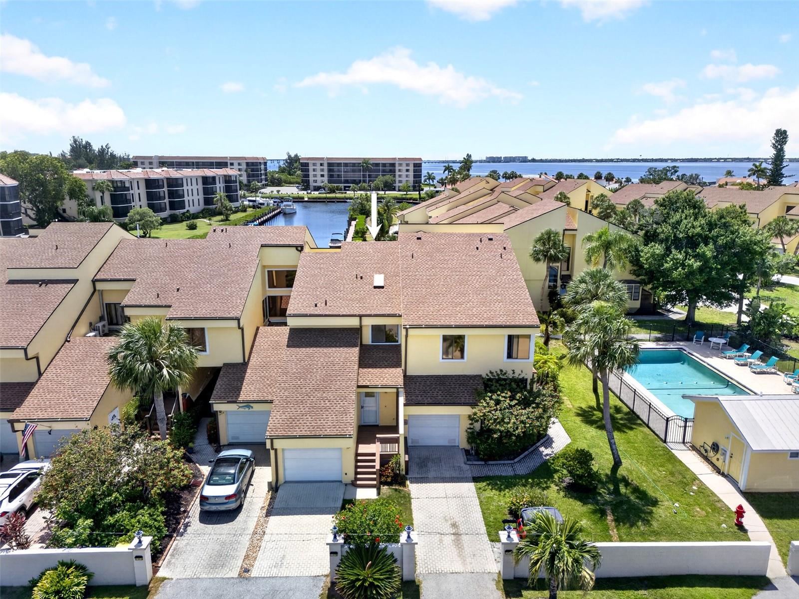 EMERALD POINTE! 2 BEDROOM, 2.5 BATH, 1-CAR GARAGE TOWNHOME IN POPULAR GATED WATERFRONT & BOATING COMMUNITY! This charming townhome offers neutral décor with a central atrium that fills the home with natural light and creates a unique indoor-outdoor living experience. The main level is designed for effortless entertaining, featuring a spacious living and dining area that flows seamlessly to the screened lanai overlooking marina views. The kitchen is well-appointed with white cabinetry, granite countertops, and a convenient pass-through window. Completing the first floor is a tucked-away half bath, perfectly positioned for guests and daily convenience. Upstairs, the primary bedroom offers high ceilings, water views, and an ensuite bath. A second spacious bedroom also features its own private ensuite, providing a comfortable and private space for visitors. Step outside to the screened lanai to take in the water views and enjoy watching the manatees and dolphins. Emerald Pointe amenities include 24-hour security, a marina, three community pools, five tennis courts, pickleball, bocce ball, a putting green, and a clubhouse with a restaurant and fitness center. The community offers quick sailboat access to Charlotte Harbor leading to the Gulf. Dock assignment close to the unit is based on availability and boat size; owners must register with the Association. Located just minutes from downtown historic Punta Gorda with fine dining, shopping, world-class fishing, and vibrant community events, this townhome is a rare find. Call for your private showing today!