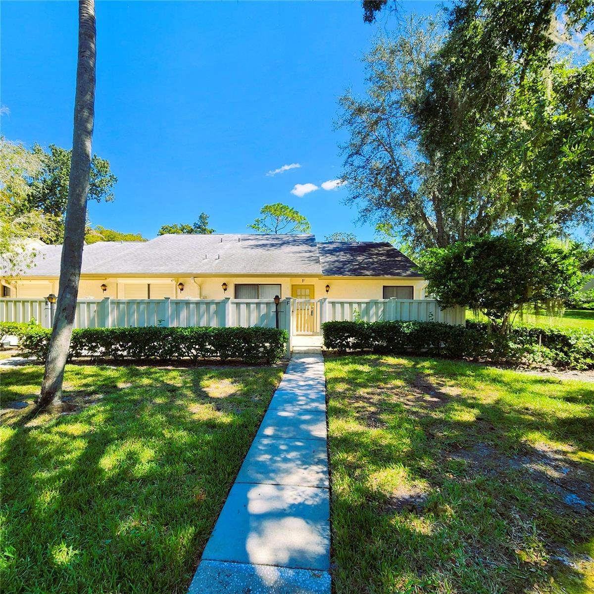 Nestled in the desirable Deer Hollow community within Pine Ridge at Lake Tarpon, this beautifully maintained end-unit villa offers the perfect combination of privacy, comfort, and low-maintenance living. A private fenced courtyard welcomes you home and leads to a spacious front patio, while a second patio just off the kitchen provides the ideal spot to enjoy your morning coffee or dine outdoors. Inside, you'll find a bright and open floor plan featuring two bedrooms, two bathrooms, soaring vaulted ceilings, and an abundance of natural light that fills the living spaces. The kitchen offers a cozy breakfast area, convenient closet laundry, and a new refrigerator (2024). The HVAC system was replaced in June 2022, providing added value and peace of mind. The spacious living and dining areas flow effortlessly into the screened lanai, complete with brand-new screens (March 2025) and a large storage closet. This flexible space also offers the potential to be enclosed for additional heated living area. The generously sized primary suite features a large closet and private access to the lanai, creating a relaxing retreat. Most furniture and furnishings will convey, making this an exceptional move-in-ready opportunity. Residents of Deer Hollow enjoy outstanding amenities, including a clubhouse, community pool and spa overlooking a picturesque lake, two tennis courts, and a playground. The all-ages community allows one pet up to 25 pounds, and the monthly maintenance fee covers exterior maintenance, roof, grounds care, water, sewer, and trash.