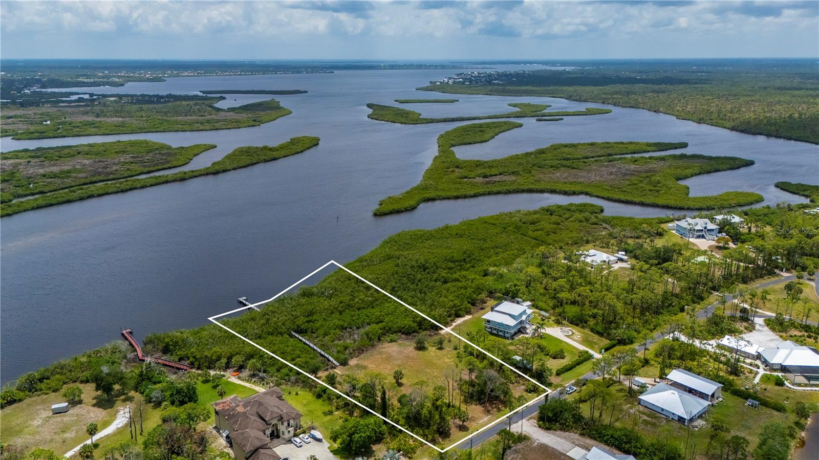 Myakka River Waterfront Acreage | 2.45 Acres | Gulf Access | Private Dock |

Rare opportunity to own Lot 6 Riverfront Drive, featuring 2.45± acres with approximately 226 feet of Myakka River frontage and Gulf access in the exclusive enclave of Myakka Country. Bordered by Myakka State Forest to the west and protected wetlands to the east, this exceptional homesite offers privacy, natural beauty, and waterfront living in Southwest Florida.

A private boardwalk and dock wind through a canopy of native Florida hammock to the open waters of the Myakka River. Enjoy boating access to Charlotte Harbor and Gulf waters, expansive river views, and breathtaking sunrises over the water. Cast a line from your private dock for snook, jack crevalle, and other sought-after sport fish, while manatees and dolphins are frequent visitors to this remarkable waterfront setting.

The upland portion of the property has been selectively cleared, and invasive exotic vegetation has been removed. A geotechnical report and recent boundary survey are available.

Conveniently located near Downtown Wellen Park, CoolToday Park, Gulf beaches, Venice, Englewood, and world-renowned Boca Grande Pass, the Tarpon Fishing Capital of the World. Outdoor enthusiasts will appreciate easy access to hiking, camping, horseback riding, and nature trails in Myakka State Forest.

Rarely available Myakka River acreage offering approximately 226 feet of Myakka River frontage, Gulf access, a private dock, exceptional privacy, and a unique opportunity to create a custom waterfront estate in one of Southwest Florida's most desirable natural settings.
