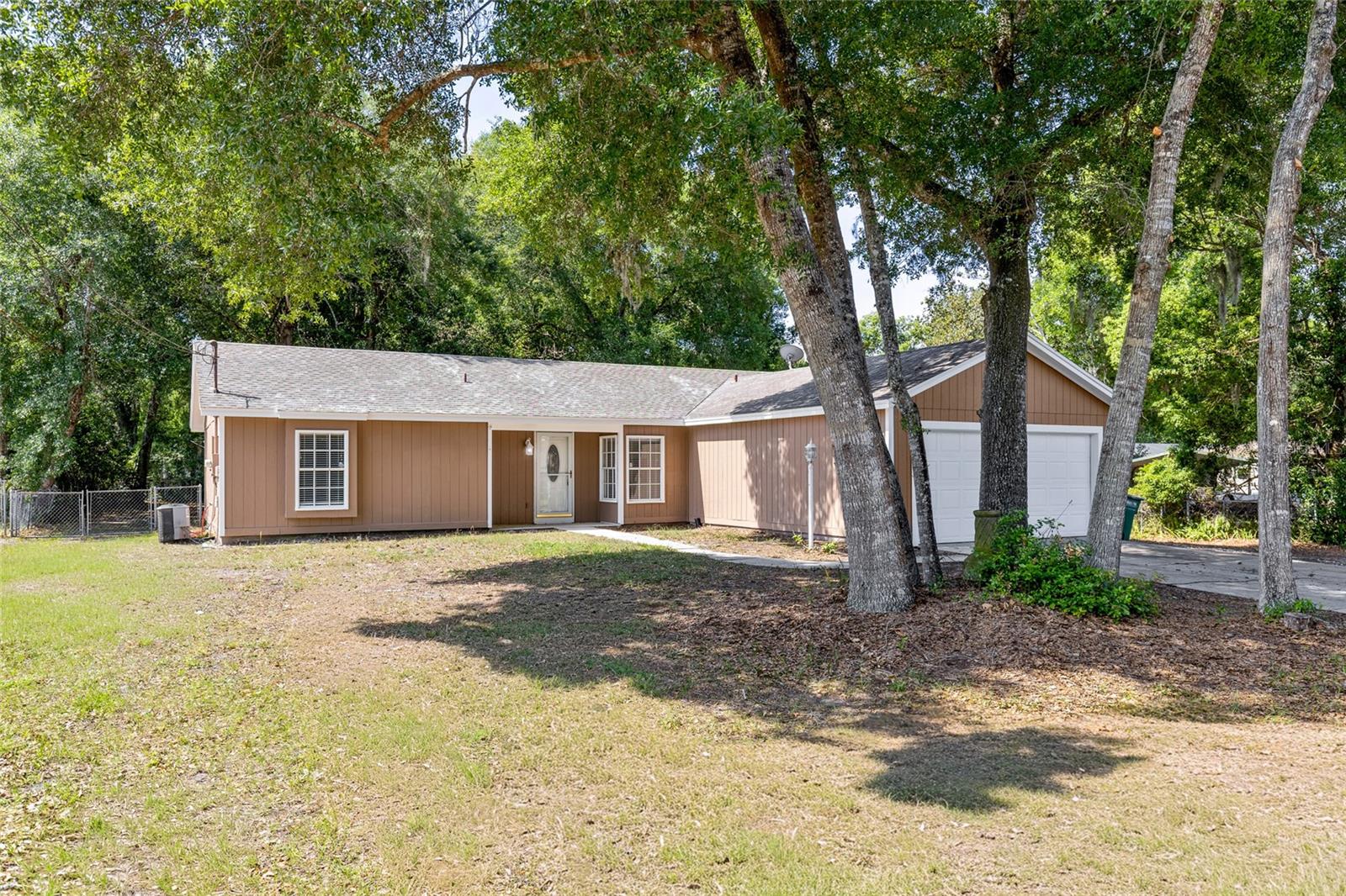 One or more photo(s) has been virtually staged. NEW ROOF AND NEW AC COMING SOON.  Welcome to this beautifully maintained 3-bedroom, 2-bathroom home just listed at 45 Lake Dr in DeBary! Situated on nearly half an acre, this property offers plenty of space and flexibility—with room to park your boat or RV and no HOA restrictions.
Step inside to an inviting open floor plan highlighted by high ceilings that create a bright and spacious feel. The thoughtfully designed split layout places the primary bedroom on the opposite side of the home from the secondary bedrooms, offering added privacy.
The kitchen features stainless steel appliances, brand-new countertops, and a cozy space perfect for a small dinette set. The home has been freshly painted both inside and out, giving it a clean, modern feel throughout.
Enjoy Florida living at its best on the screened-in back porch—the perfect spot to sip your morning coffee or unwind with a glass of wine in the evening. The fully fenced backyard also includes two storage sheds, offering plenty of room for tools, hobbies, or extra storage.
The garage is equally impressive, boasting a freshly painted floor, a brand-new water heater, and a full wall of storage cabinets to keep everything organized. The entire home was repiped in 2022, and the septic tank was recently pumped.
Conveniently located near shopping, dining, and everyday essentials, this home combines comfort, functionality, and location. Don’t miss your chance—come see this beautiful home today!