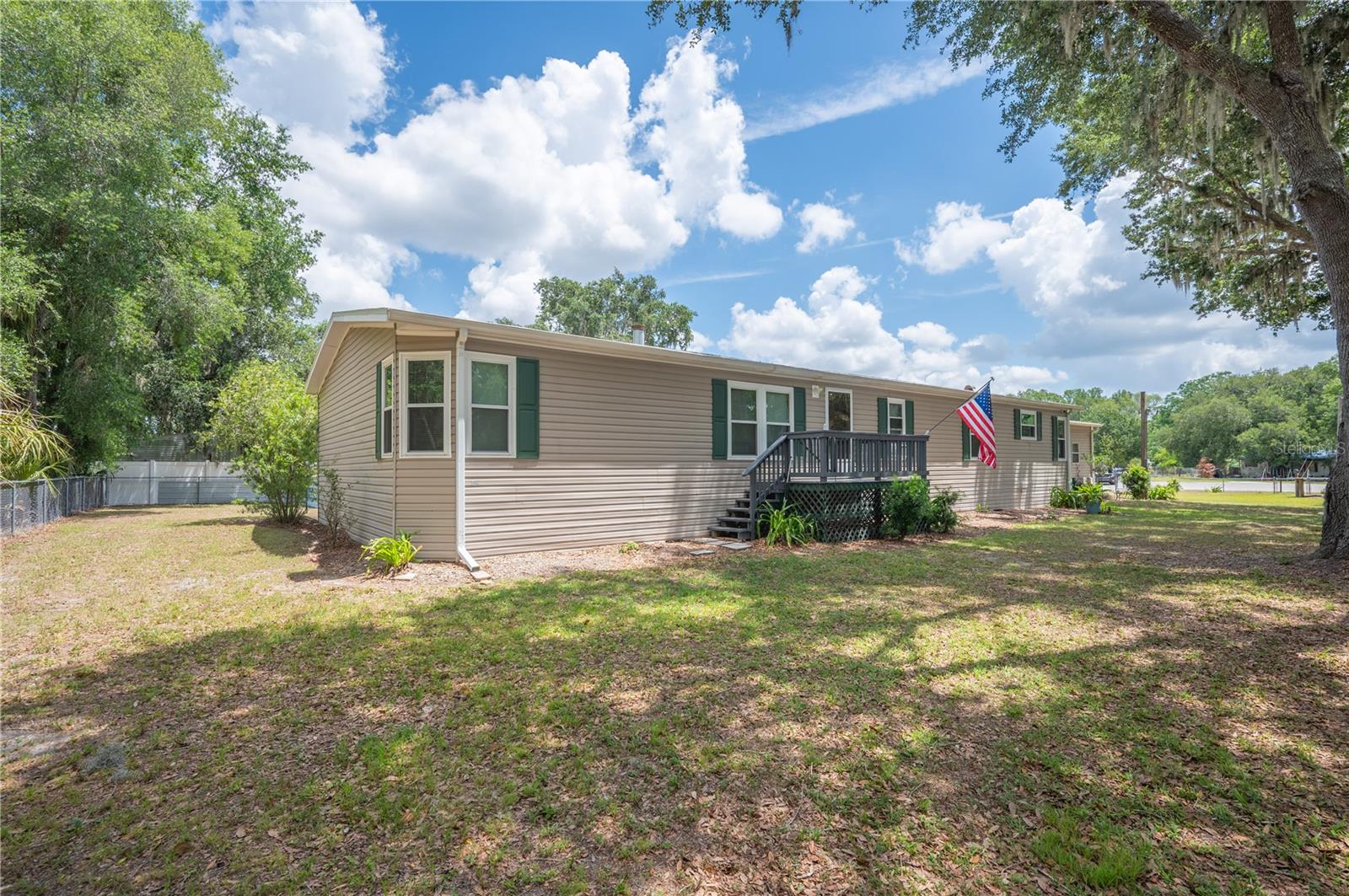 Welcome home to peaceful country living in the heart of Mulberry! Nestled on a spacious and fully fenced .64-acre cul-de-sac lot, this well-maintained 4-bedroom, 2-bath manufactured home offers the perfect blend of comfort, privacy, and functionality. Inside, you’ll find a spacious layout with plenty of room for family and entertaining, all showcasing the pride of ownership and care this home has received over the years. Major improvements include a roof replaced in 2023, newer A/C unit, and updated windows for added efficiency and peace of mind. Outside, enjoy the convenience of a 2-car garage, ample yard space for pets, toys, or gardening, and the quiet setting of a low-traffic cul-de-sac. Clean, cared for, and full of potential, this property is a great opportunity to enjoy extra space and quiet living!