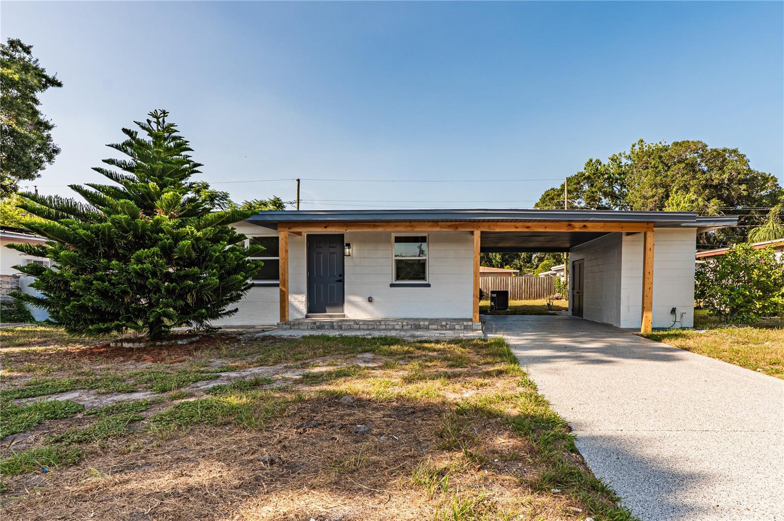 Welcome to this fully renovated 3 bedroom, 2 bathroom home! Every inch has been thoughtfully updated, creating a clean, modern space that's both stylish and functional. The open floor plan flows seamlessly into the beautifully remodeled kitchen, featuring quartz countertops, custom cabinetry, stainless steel appliances, and ample storage. Both bathrooms have been completely renovated with designer tile, glass-enclosed showers, and modern finishes, while luxury vinyl plank flooring runs throughout the home. A separate laundry and storage room adds extra convenience. Outside, you'll find fresh exterior paint, attractive wood accents, a covered carport, and a spacious backyard with plenty of room to entertain, garden, or relax and enjoy the Florida weather. Conveniently located near shopping, dining, Clearwater's world famous beaches, and major highways, this move in ready home is ready for its new owners!