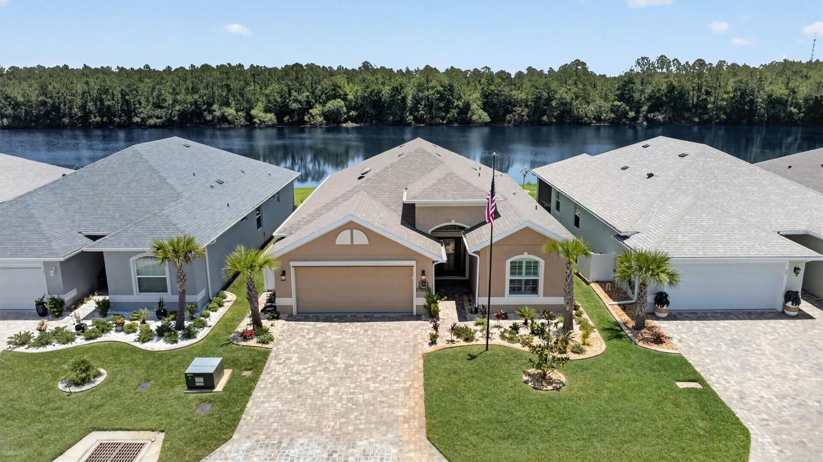 Welcome to 37 Lagoon Way in the gated 55+ community of Matanzas Lakes. This like-new 2023 Sea Gate home offers move-in ready, low-maintenance Florida living with peaceful water views. Beautiful curb appeal sets the tone, featuring a paver driveway, iron fencing, a custom flagpole, and vibrant landscaping. Inside, you'll find a light-filled open floor plan with soaring ceilings and a seamless flow between the kitchen, dining, and living areas. The kitchen is designed for both everyday living and entertaining, with quartz countertops, high-end appliances including a gas range, and upgraded cabinetry with ample storage and workspace. Modern finishes, upgraded lighting, and ceiling fans create a clean, comfortable feel throughout the main living spaces. The home offers two oversized bedrooms, two full baths, and a versatile flex room that can be used as a home office, den, or third bedroom. Step outside to the screened patio and take in tranquil water views - perfect for morning coffee and relaxing evenings. All the upgrades have already been completed for you, including plantation shutters, custom California Closets, epoxy garage flooring, an electronic garage screen, tankless water heater, and a rust-prevention irrigation system--so you can move in and enjoy from day one. Matanzas Lakes offers a welcoming gated lifestyle with a community pool, pickleball courts, and beautifully maintained grounds. Conveniently located near shopping, dining, healthcare, golf, and close to Flagler Beach. Move-in ready and waiting for you -- schedule your private tour of 37 Lagoon Way today.