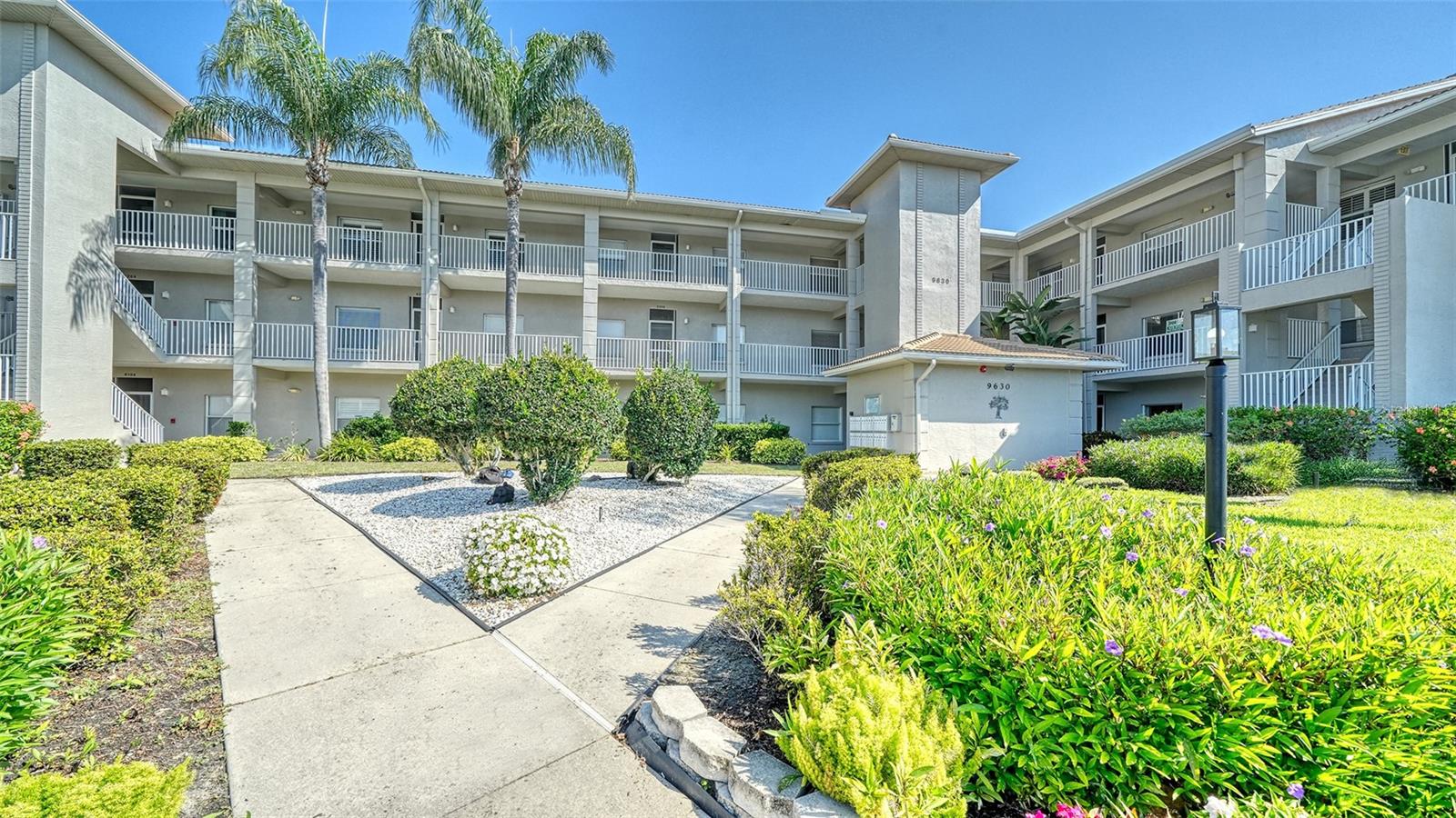 ENJOY THE VIEW FROM THE THIRD FLOOR AT CLUB SOUTH CIR. IN STONEYBROOK G&CC, picturesque views abound of the golf course  across the 3rd fairway from the glassed and screened lanai of this stunning residence, being sold TURN-KEY FURNISHED, boasting VAULTED CEILING, adding to the spacious feeling of the open floor plan.  The UPDATED KITCHEN has solid-surface countertops and new cabinets, and a charming cafe table for two sits under the large window that lets light fill the room.  The dining area is open to the well-furnished living area, which seamlessly flows onto the glass-enclosed lanai, a year-round living space.  The master bedroom easily holds a king bed and custom closets and has an adjoining master bathroom with granite countertop and a tiled and glassed walk-in shower.  The 2nd bedroom is conveniently located at the front of the condo, adjacent to the second bathroom, which also has a tiled shower and tub area.  This residence shows like a model and has been lovingly cared for.  Club South is a desirable area with its own tennis/pickleball court, heated pool with screened-in lanai, outdoor granite kitchen, and grill area.  Every unit has an assigned covered parking space and a storage locker, ideal for beach chairs, pool toys, or golf clubs.  The newly completed modernization of the 18-hole golf course is said to be one of the best courses on the West Coast of Florida.  Additional amenities incude Lighted Har-Tru tennis/pickleball courts, pro-shop, well-equipped fitness center, bocce court, putting greens, driving range, library, huge heated pool and spa, full service restaurant and bar, a new outdoor dining patio, walking and biking trails, and many planned activities like yoga, mahjong, line dancing, trivia, bingo, and much more.  Stoneybrook is centrally located and close to the Legacy walking and biking trail, Costco, the YMCA, many restaurants and grocery stores, and less than 15 minutes from the sugar sandy beaches of Siesta Key, all making Stoneybrook Golf & Country Club a great place to live the Florida lifestyle.