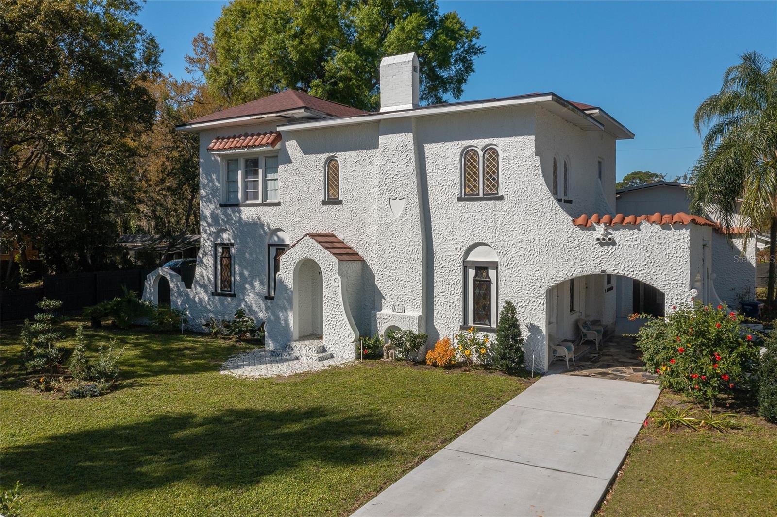 Stunning 2 story 3 bath Spanish home with attention to details.  This home has been renovated, roof was complete in 2019, painted inside and out in 2020, new A/C in 2023, electric and plumbing and the sprinkler system in 2023.  Upon entering into the family room, you will  immediately notice the vaulted beam ceilng along with the 20foot high fireplace.  There are built-ins and bookcases throughout the home.
Walking up into the kitchen, there is granite throughout and stainless steel appliances, along with a breakfast nook.  There is a beautiful flooring throughout the home.  On the first floor, there is another sitting room,along with a bedroom and a additional renovated full bath.  On the second floor, it provides the laundry room and two more bedrooms and two full bathrooms that have been tastefully renovated.  Going outside, there is convered area where you can relax and the property is completely fenced in.  Another great feature is a detached studio that has been