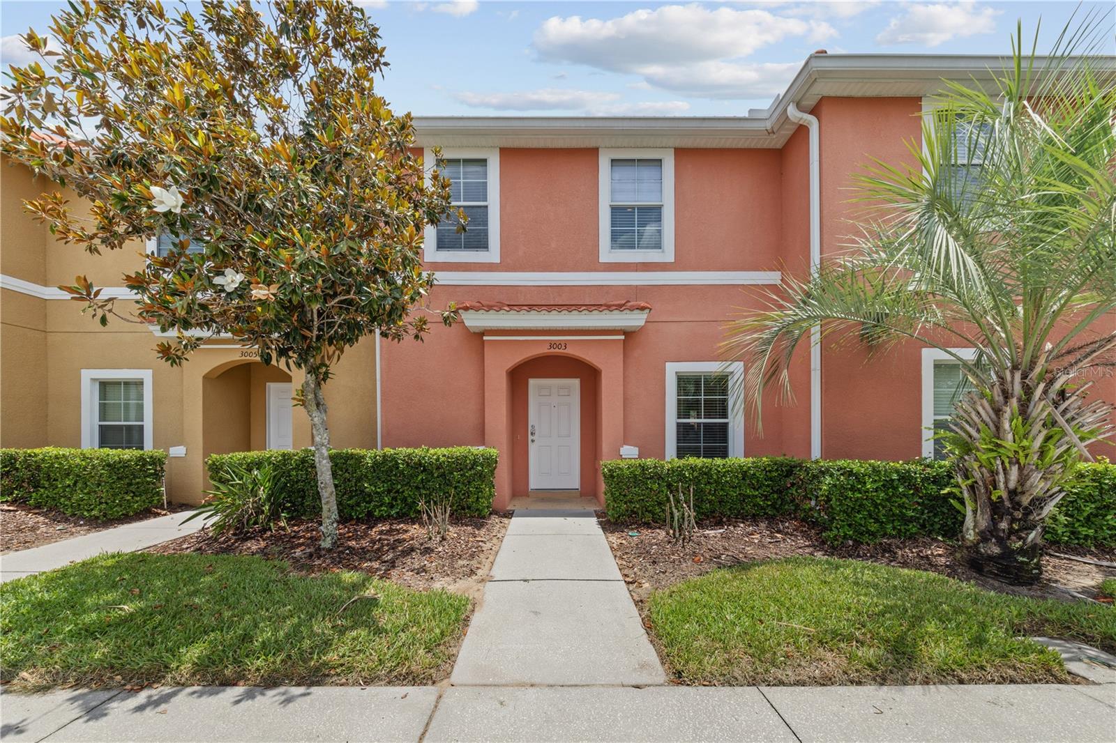 Welcome to Encantada Resort, a popular gated community located just minutes from Walt Disney World, Universal Studios, SeaWorld, and many of Central Florida's top attractions. This fully furnished 2-bedroom, 2.5-bath townhome offers comfort, convenience, and excellent rental potential. The first floor features a bright and open living and dining area, an updated kitchen with granite countertops, plenty of cabinet and counter space, a half bath, and an in-unit laundry room. Sliding glass doors lead to a private screened lanai with a hot tub, outdoor seating area. Upstairs, both spacious bedrooms have their own en-suite bathrooms, walk-in closets, and TVs, providing privacy and comfort for owners and guests. The home is being sold fully furnished, making it ready to enjoy or rent immediately. Zoned for short-term rentals and with a strong rental history, this property is a great opportunity as a vacation home, investment property, or primary residence. Encantada offers resort-style amenities including a community pool and spa, fitness center, clubhouse, playground, game room, and walking paths. HOA fees cover exterior maintenance, landscaping, cable, and internet for easy ownership. Conveniently located near parks, restaurants, shopping, entertainment, Old Town Kissimmee, and major highways. This turnkey property offers the best of Florida living and investment potential.