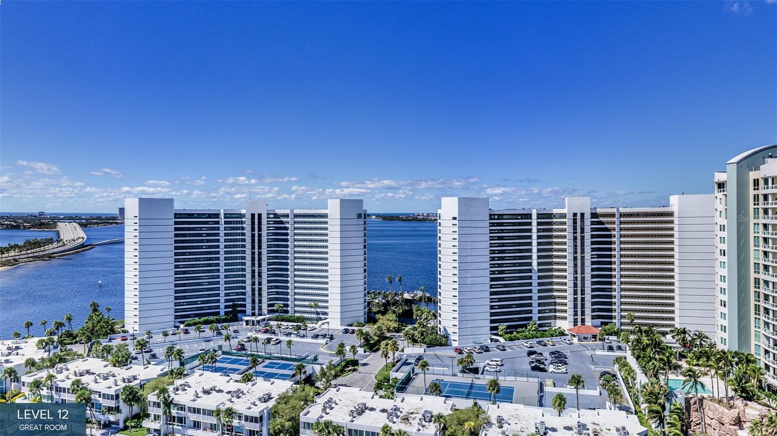 Virtually Staged. Pre-Construction. To be built. Back on the market and the only residence currently offered on the fourth floor, this is a rare opportunity to secure one of the most uniquely positioned homes in the entire building—where architecture is intentionally designed to live in constant dialogue with Sarasota Bay.

With three expansive exposures, Residence A is immersed in light from sunrise over the water to sunset across the downtown skyline. Every moment of the day becomes part of the view.

A series of three private terraces extends the living experience outdoors, including one with a fully equipped outdoor kitchen, seamlessly connected to the great room—an open, airy space designed for both entertaining and quiet enjoyment. The kitchen is complemented by a generous walk-in pantry, blending beauty with everyday functionality.

A separate den offers a warm, intimate retreat for reading, media, or relaxation, while a discreet powder room adds convenience for guests.

The residence is thoughtfully designed for privacy and flow. Two guest suites open to a third terrace with city views, while a third guest suite is perfectly positioned on the corner, capturing dramatic water-to-skyline vistas.

The primary suite is a true sanctuary—featuring dual walk-in closets and a spa-inspired bath with a deep soaking tub, double vanity, and oversized dual-entry shower, all designed for a sense of calm and retreat.

As part of The Ritz-Carlton global standard of service and refinement The Ritz-Carlton, residents enjoy an unmatched level of attention, including a dedicated on-site team, 24-hour concierge and valet, housekeeping services, and curated food and beverage offerings from a private on-site service kitchen.

Beyond the residence itself, ownership includes access to an extraordinary collection of private amenities overlooking the yacht harbor, as well as membership in The Harbor Club—offering nearly 20,000 square feet of wellness, social, and lifestyle spaces exclusively for tower residents.

This is more than a residence—it is a front-row position to the water, the skyline, and the next chapter of Sarasota living.