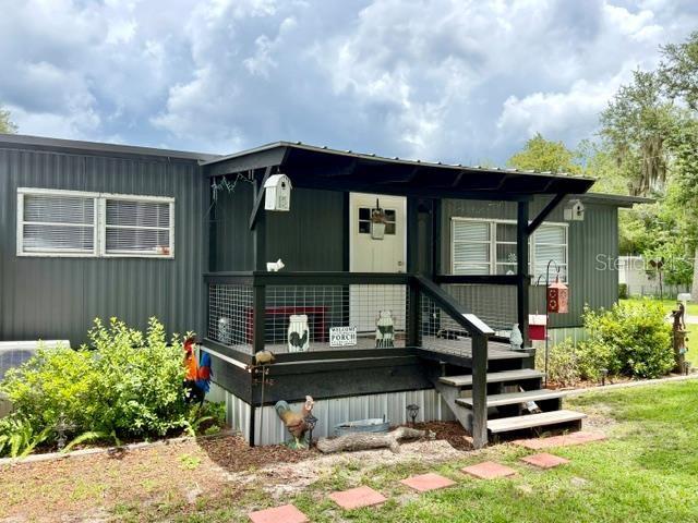 MUST SEE!! Welcome to this beautifully remodeled and EXCEPTIONALLY well-maintained manufactured home in Chiefland, Florida, conveniently located only minutes from US 19 with Walmart, Tractor Supply, Aldi‘s and other restaurants. Hideaway Park is located near the entrance to Manatee Springs State Park and Chiefland Golf & Country Club. Whether you’re looking for a full-time residence, weekend getaway, or vacation rental opportunity, this charming property offers comfort, style, and an unbeatable location. Inside, you’ll find 2 bedrooms and 1.5 bathrooms with tasteful updates throughout every room. The home has been completely remodeled, featuring luxury vinyl plank flooring, attractive shiplap walls, a warm wood accent wall in the dining area, updated LED lighting, all new electrical receptacles, and three energy-efficient mini-split units for customized year-round comfort. The kitchen is equipped with stainless steel appliances and includes a pantry with a barn door, complementing the home’s fresh, modern design. A durable standing seam metal roof provides lasting value and peace of mind. Outside, the property is designed for both convenience and entertaining. A single attached carport is located on one side of the home, while a double attached carport leads directly into the enclosed porch and the back entrance off the kitchen. The washer and dryer are located in the enclosed porch for added convenience. The privacy-fenced backyard creates a secluded retreat, complete with a large covered patio that’s perfect for outdoor dining, entertaining, or relaxing with family and friends. There is also plenty of outdoor storage and workshop space, including a three-bay metal workshop, making this property ideal for hobbies, projects, and extra storage needs. TOO MANY UPGRADES TO LIST! A cute chicken coop adds to the country feel and charming decor of the property. Located just moments from Manatee Springs State Park, you’ll enjoy easy access to crystal-clear springs, the Suwannee River, boating, kayaking, swimming, hiking, and some of North Florida’s best outdoor recreation. This move-in-ready property is an excellent opportunity for a primary residence, seasonal retreat, or investment property in a highly desirable location.