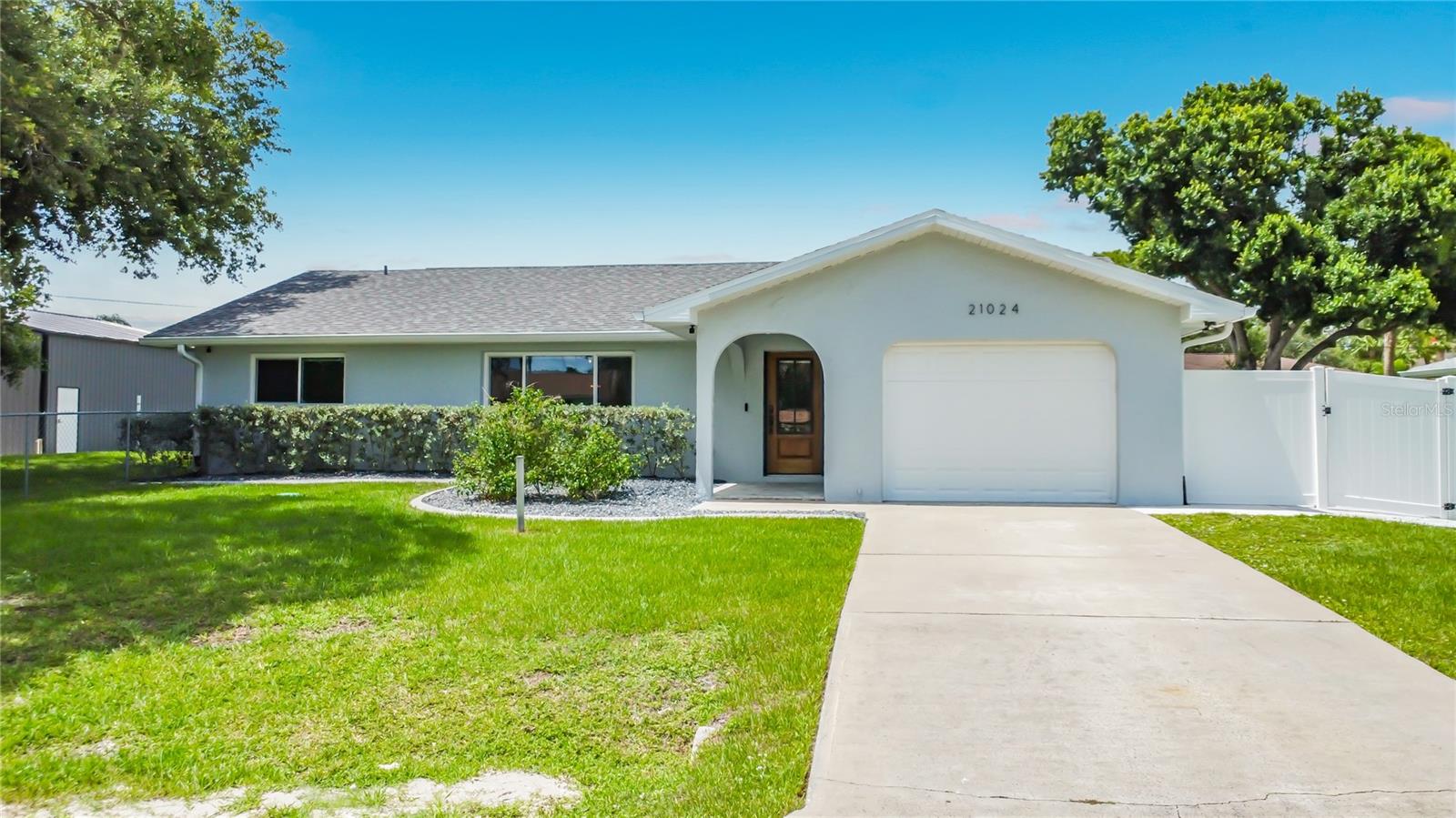 Beautifully updated home on Denise Ave in Port Charlotte featuring a rare **fenced double lot (160’ x 120’)** offering exceptional space, privacy, and flexibility. This spacious **3-bedroom, 2-bath home plus bonus room** boasts **2,023 sq ft of living area** and has been **fully updated in 2021** with modern finishes throughout.
-
Inside, you’ll find **PGT impact windows**, **luxury vinyl plank flooring**, and a stunning kitchen with **shaker-style cabinets** and **stainless steel appliances**. The primary suite includes custom built-in shelving and a **secure gun safe** in the walk-in closet. Major systems were also upgraded in 2021, including a **new roof** and a high-efficiency **Trane 21 SEER variable-speed A/C system with 3 zones and advanced air purification**.
-
Step outside to your private oasis featuring a **2023-built 14’ x 32’ saltwater pool with sun shelf and spillover spa**, heated by an energy-efficient heat pump. Enjoy entertaining on the expansive **paver deck areas (27’ x 15’ and 10’ x 36’)**.
-
Car enthusiasts, hobbyists, or business owners will love the impressive **35’ x 40’ detached garage/barn (2024)** with **12’x12’ and 10’x10’ overhead doors**, spray foam insulation, and its own **18 SEER Trane A/C system**, making it fully climate-controlled year-round.
-
This property offers a perfect combination of modern upgrades, outdoor living, and unmatched functional space—all in a prime Port Charlotte location. Don’t miss this unique opportunity!