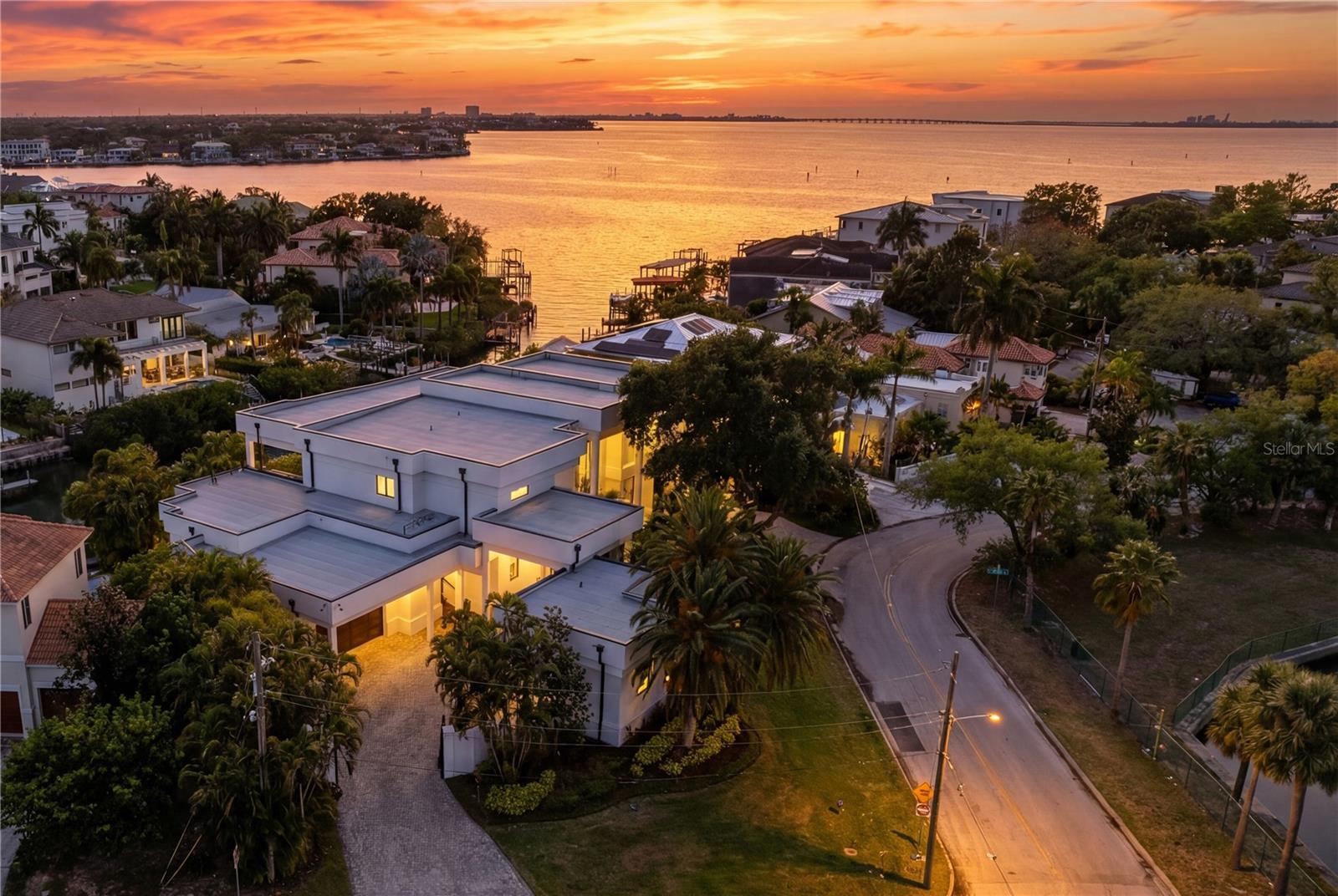 Welcome to this rare, gated waterfront estate situated on a double lot in the coveted Beach Park neighborhood. This all block, architectural wonder built by Alvarez Homes offers timeless elegance and modern luxury across 9,000 square feet of meticulously designed living space. Revealing an impressive layout that features six bedrooms and eight bathrooms, this residence also showcases a separate detached guesthouse and full bath that provides additional sleeping quarters and income potential. 
From the moment you enter the grand foyer, you are greeted by a breathtaking indoor floor to ceiling waterfall and graceful winding staircase, setting a serene tone that continues throughout the home. Designed for both entertaining company and everyday comfort, this residence includes soaring ceilings, an expansive living and dining area, and a light and bright kitchen with quartz counters, Sub Zero appliances and windows facing west that overlook the water. There is an enormous kitchen island with storage on either side that is perfect for serving family and guests. The walk-in pantry works like a back kitchen offering an extra refrigerator, microwave, and ample shelving providing additional food storage. A temperature-controlled glass wine cellar is perfect for the wine enthusiast. 

 

Showing off its impressive floor plan, this home boasts three unbelievably large owner’s suites with attached en-suite bathrooms. Two of the owner’s suites are located on the first floor, on either side of the home, providing full privacy. The third owner’s suite is on the second level offering unparalleled flexibility for multigenerational living or hosting company in style. Three additional bedrooms and two attached baths are located upstairs and can be easily accessible using the home’s elevator. Back on the main floor, there is a separate office with French doors and built-in cabinets, as well as a flex room with pilates flooring for the ultimate home gym, yoga studio or playroom.

 

A large living room slider provides easy access to the outdoor kitchen with a gas grill, pizza oven, flat top cooker, refrigerators and beer tap where your guests can lounge and relax by the pool and spa. The attached dock and covered slip provide ample room for your boat with open access to the bay and gulf, perfect for embracing Tampa’s waterfront lifestyle. 

 

The exterior is equally impressive, featuring mature landscaping enhanced by elegant lighting, a low-maintenance turfed backyard, and a stately circular paved driveway behind a secure double gated entry. The west-facing frontage captures spectacular sunset views, bathing the home in warm, golden light each evening. The detached private guesthouse provides additional accommodations for visitors, nanny or staff, while recent upgrades—including new AC units, a new roof, and whole house and lighting automation—offer peace of mind and modern efficiency. 

 

Ideally situated just minutes from Tampa International and a private jet airport, I-275 and the Veterans Expressway, this home offers unmatched convenience to Tampa’s premier hospitals, shopping, dining, Raymond James Stadium, Benchmark Arena, top-rated public and private schools and is only a block away from the grocery store allowing the home to blend luxury living with everyday ease. This is more than a home—it’s a statement of lifestyle, sophistication, and waterfront excellence. Come and see this beautiful property.  It’s ready to welcome you home!