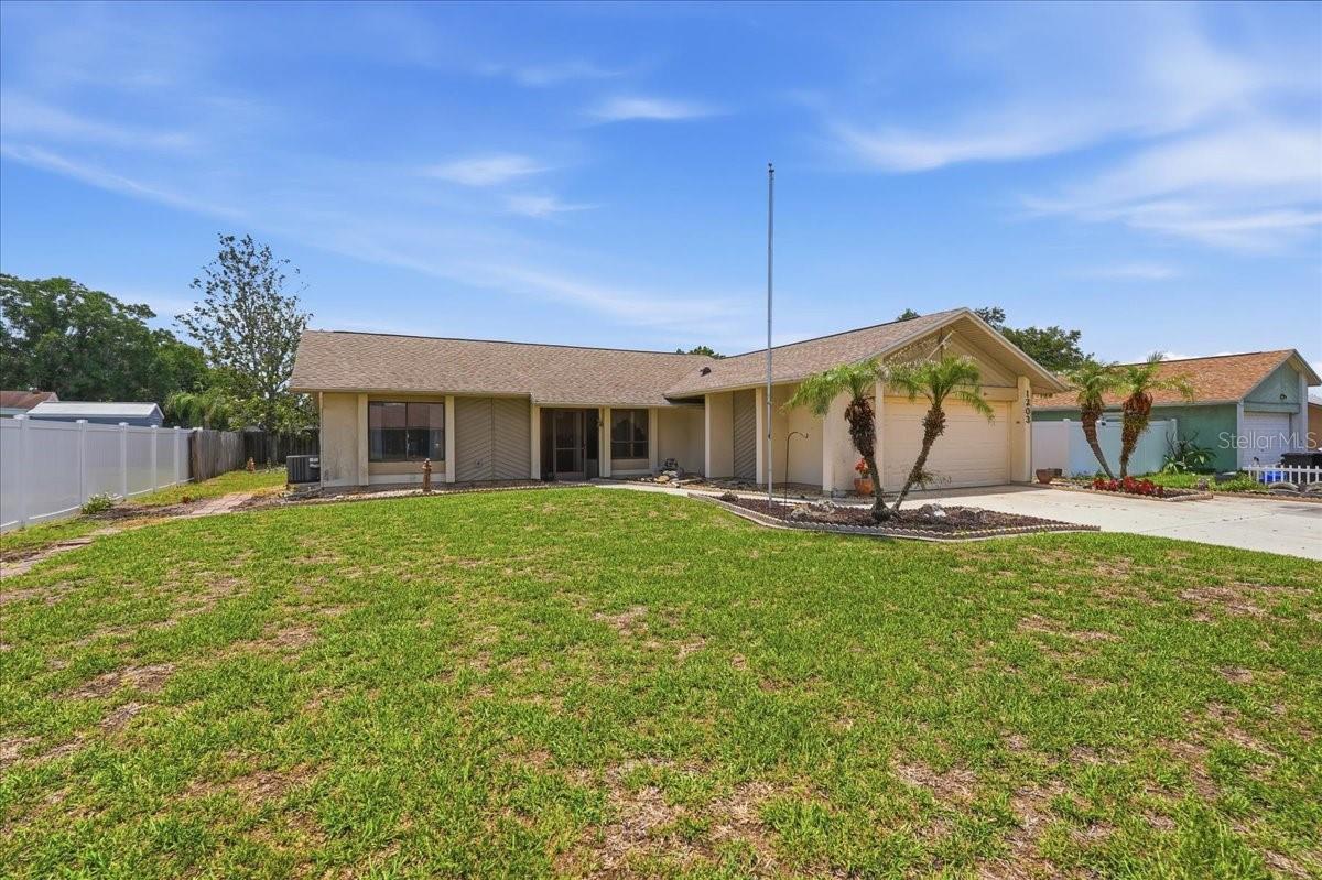 Welcome to this 2 bedroom, 2 bathroom, 2-car garage home that offers great value in a desirable neighborhood with NO HOA.  Roof 2022, HVAC 2023.  Tile and wood laminate flooring throughout the home.  The open living room and dining room are comfortably nestled between  kitchen and bedrooms.  The primary suite includes a large walk-in closet, en suite bathroom with shower, ceiling fan and sliding doors to the back yard.  The guest bath includes a tub/shower combination.  This kitchen offers more than just a refrigerator, range, dishwasher and microwave.  Plentiful cabinets, a breakfast bar, closet pantry and newer disposal allow for mealtime creativity - a true recipe for success.  The inside utility leads to the garage on one side and side yard with a useful shed on the other.  Located near shopping, restaurants, and great schools.  Only minutes to I-4.  Come visit this home today to see all that it has to offer.