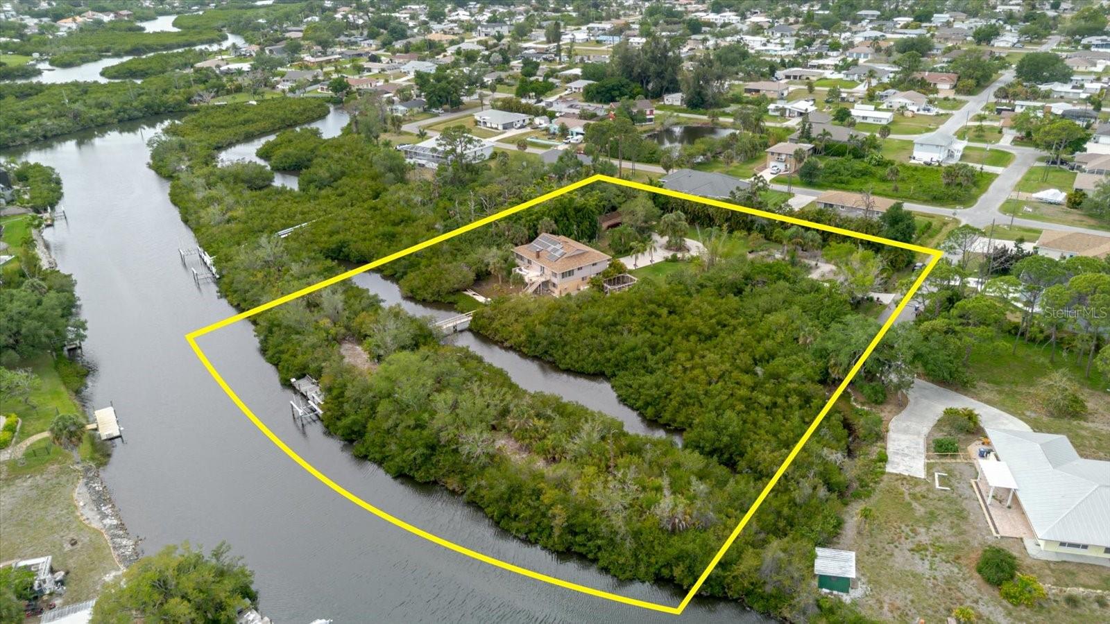 Once in a generation does a property like this come to market.
Commanding over 2 acres of private waterfront land at the end of a quiet cul-de-sac, 4190 Strombus Road is a fully self-sufficient, meticulously upgraded estate that defies comparison. Three combined parcels exceeding 2 acres deliver the space, privacy, and versatility virtually impossible to find in Southwest Florida at any price. Now offered at $1,099,000 — a decisive adjustment by a seller who values the right buyer over the wrong price.
Pass through the electric gated entrance onto a concrete drive framed by live areca boundary fencing, 33+ fruit trees, a caged vegetable garden, and a private enclosed chicken coop — engineered for those who demand complete independence and connection to the land. A 100-foot footbridge leads to your own private detached island. A 7,000 lb boat lift and private dock provide direct access to Alligator Creek and the waterways of Southwest Florida. South Venice Beach Ferry access is available via annual residential pass with optional boat launch, and beach access is less than 5 minutes away.
The 2,312 SF 2-story masonry residence features 3 bedrooms, 3 full bathrooms including a 2024 walk-in shower, wood-burning fireplace, 2 skylights, dumbwaiter, open concept kitchen and living areas, home office, game/recreation room, family room, wrap-around balcony, upper deck with awning, screened lower lanai, and a 2-car garage plus carport. Included appliances and stairlift add immediate convenience. Nearly $500,000 in documented improvements — serious, deliberate infrastructure investment throughout.
This home is built to operate through anything Florida delivers. The 2025 Garrison Flood Barrier System, impact-rated hurricane windows, Storm Smart lanai protection and harmonic entry shutter deliver unmatched storm defense. Power independence is absolute: 25 solar panels, 2018 solar installation, Tesla Powerwall (13,500 kWh), Tesla Dueto Flood system, 250-gallon propane tank, and a whole-home Generac generator. Well water, upgraded 2021 septic, 500-gallon rainwater tank, and dual irrigation complete a genuinely off-grid capable estate.
Recent improvements include new roof (2022), two new A/C systems (2024), new water system (2024), full downstairs renovation with HardiBoard, epoxy flooring, raised electrical to 6 feet, new interior doors, new lower bathroom and fresh exterior paint (all 2024), new garage doors (2023), and overhead garage storage (2025). 6-camera security, central vacuum, and UV water filter throughout.
Residents enjoy the Legacy Trail connecting Venice to Sarasota and South Venice Civic Association membership with pickleball and year-round amenities. Zoned OUC/Open Use Conservation. A-rated Venice schools: Elementary, Middle, and Senior High.
This is the right property for exactly the right buyer — someone who recognizes what 2+ acres of private waterfront land with $500,000 in documented improvements and genuine off-grid capability actually represents. The seller is ready. The price reflects the market. The opportunity is now.
See attached Features Sheet and Property FAQ for complete improvements and specifications.
