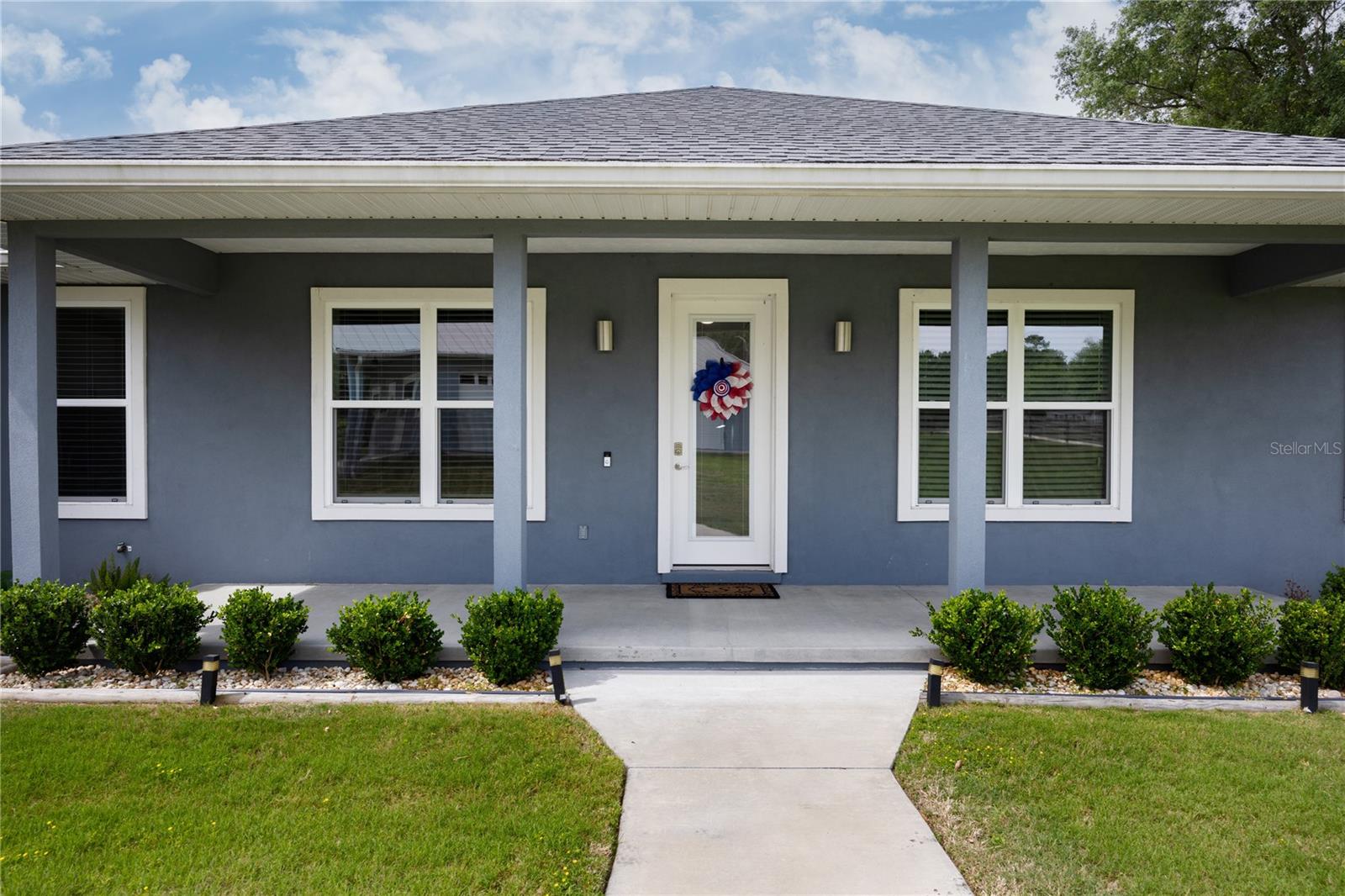 CUSTOM BUILT BLOCK HOME with Attached oversized 2 car garage and separate Detached 1200 Sq Ft 3 bay Garage/Workshop with 1/2 bath. Home is split floor plan with many upgrades and extra's to mention. Home is located on FENCED 5.78 acre Lot. Gated / Paved entrance. Dawn to Dusk power pole illuminates front of home. Custom Cabinetry throughout house. Granite Countertops. Tiled Flooring Throughout.  Whole House Surge Protection, Generac Generator, Gutters and Gutterguards on house and garage. Low HOA fee $350 year.