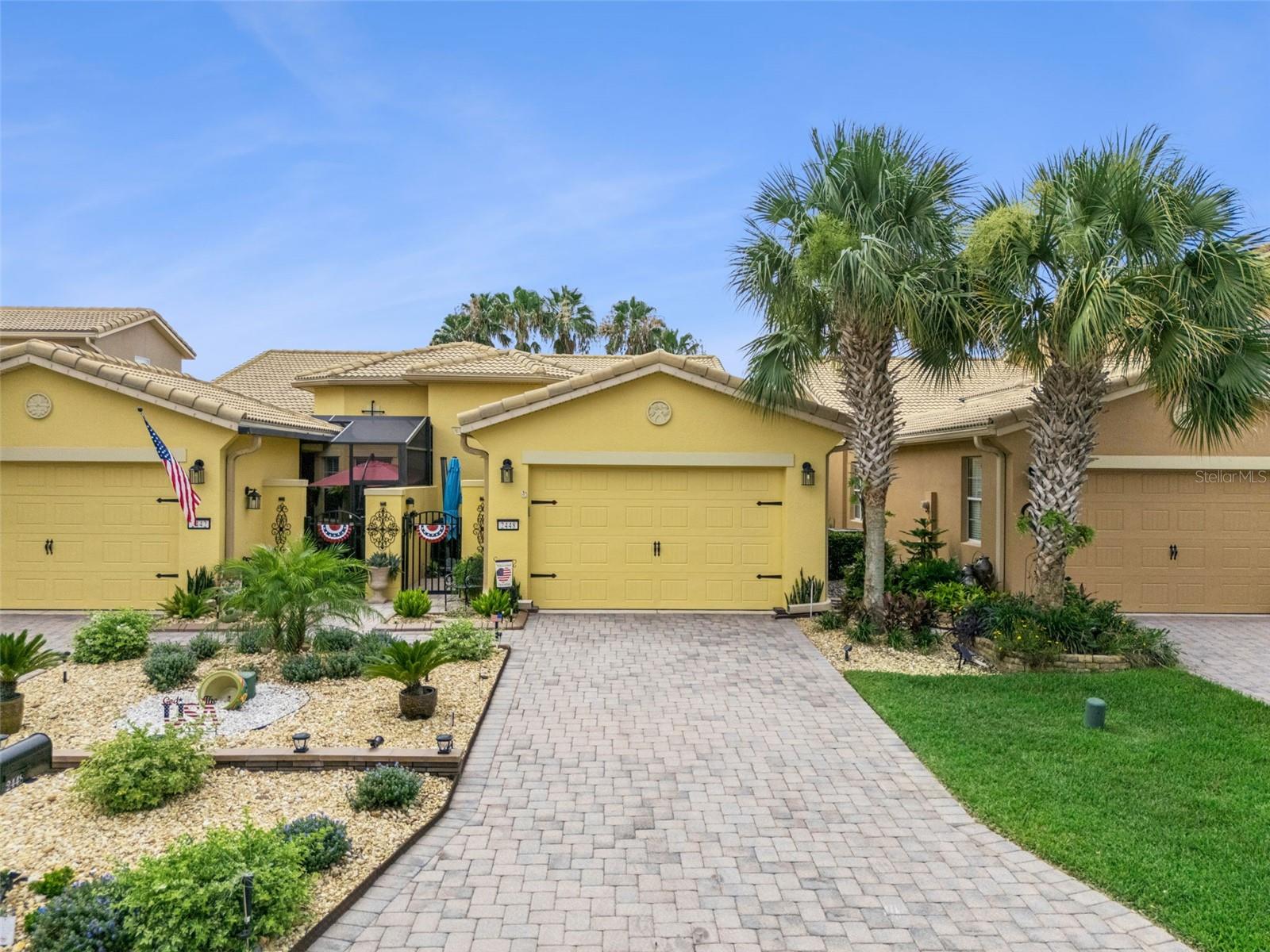 Welcome to this charming 3-bedroom, 2-bath Cortina Villa perfectly positioned on the golf course with breathtaking pond views. Ideally located near the Village Center, this home combines convenience, comfort, and the relaxed Florida lifestyle you've been dreaming of.
Step through the private courtyard and screened entry into a welcoming interior highlighted by a beautiful leaded-glass front door. The spacious living and dining areas are filled with natural light and showcase stunning water views, creating the perfect setting for both everyday living and entertaining.

The beautiful open kitchen  features granite countertops, a convenient breakfast bar, a double-door pantry, and an adjoining beverage room. A new washer and dryer (2022) add to the home's functionality and convenience.

The primary suite is a peaceful retreat featuring a tray ceiling, walk-in closet, and tranquil pond views. The bedroom window is equipped with one-way privacy film that reduces heat and glare while allowing you to enjoy the view without sacrificing privacy. The en-suite bath offers dual vanities, a dedicated knee-space vanity area, and an oversized walk-in shower with built-in seating.

The versatile third bedroom is ideal as a guest room, home office, or hobby space and features luxury vinyl flooring and a Murphy bed that is also a desk and bookshelf.  The nearby guest bathroom has been upgraded with a custom walk-in shower for added comfort and style.

Enjoy Florida's beautiful weather year-round from the covered lanai with an extended screened enclosure overlooking the golf course and pond. Recent improvements include interior painting (2023), exterior painting (2022), and the addition of recessed lighting and ceiling fans, giving the home a fresh, modern feel. Furniture and Golf Cart are available for purchase!

Located within the award-winning 55+ community of Solivita, residents enjoy resort-style amenities including 14 community pools, 2 championship golf courses, 3 on-site restaurants, over 250 social clubs, a vibrant village center, and more than 4,200 acres of beautifully maintained grounds. HOA dues include lawn care, irrigation water, highspeed internet and cable service — delivering true maintenance-free living.