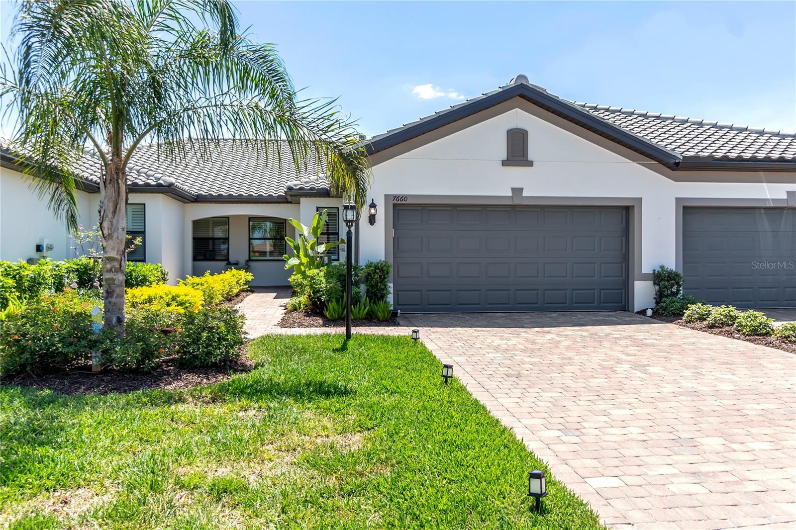 Positioned at 7660 Summerland Cove, this beautifully optimized residence offers a strategic blend of premier location and lifestyle. Bypassing the friction of new-construction waitlists and builder delays, this Seagrove-model attached villa provides an immediate, turnkey transition into the exclusive, gated enclaves of Del Webb. It sits perfectly within the footprint of Lakewood Ranch—frequently recognized as the number one multi-generational master-planned community in the country.

Spanning 1,458 square feet, the thoughtfully designed floorplan features two bedrooms, two full bathrooms, and a versatile flex space currently utilized as a media room and guest accommodation. The open-concept layout seamlessly connects the main gathering space to a fully screened lanai via expansive sliding glass doors, maximizing the coveted Florida indoor-outdoor lifestyle. The kitchen is beautifully appointed with stainless steel appliances, premium white cabinetry, and extensive quartz counter space engineered for effortless entertaining. Ensuring total privacy, the primary suite is completely separated from the guest wing, featuring a large walk-in closet and an elegant en-suite bath with dual vanities and an oversized, decorative-tile walk-in shower.

Operating on a low-maintenance footprint, this home is engineered for privacy and ultimate ease of ownership. The attached villa architecture provides a highly secure, lock-and-leave baseline, making it an ideal seasonal retreat or a permanent winter residence. It completely eliminates the heavy exterior upkeep associated with massive, detached estates, allowing you to invest your time directly into the lifestyle rather than home maintenance.

The true value of this property lies in the elite Del Webb amenities coupled with its premier location. Residents enjoy immediate access to a 21,000-square-foot clubhouse, a state-of-the-art fitness facility, and resort-caliber aquatic amenities. The gated grounds are designed for active living, featuring a comprehensive racquet sports complex (tennis, pickleball, and bocce), private walking trails, and an event lawn—all curated by a full-time lifestyle director. Beyond the gates, you are strategically positioned at the geographic center of Lakewood Ranch. This ensures immediate access to top-tier hospitals and medical facilities, the luxury retail and dining of UTC, and the rapidly expanding Waterside Place. Furthermore, this prime location serves as your gateway to the world-renowned Gulf Coast beaches and the vibrant arts, theater, and culinary scene of Downtown Sarasota’s famed Cultural Coast.