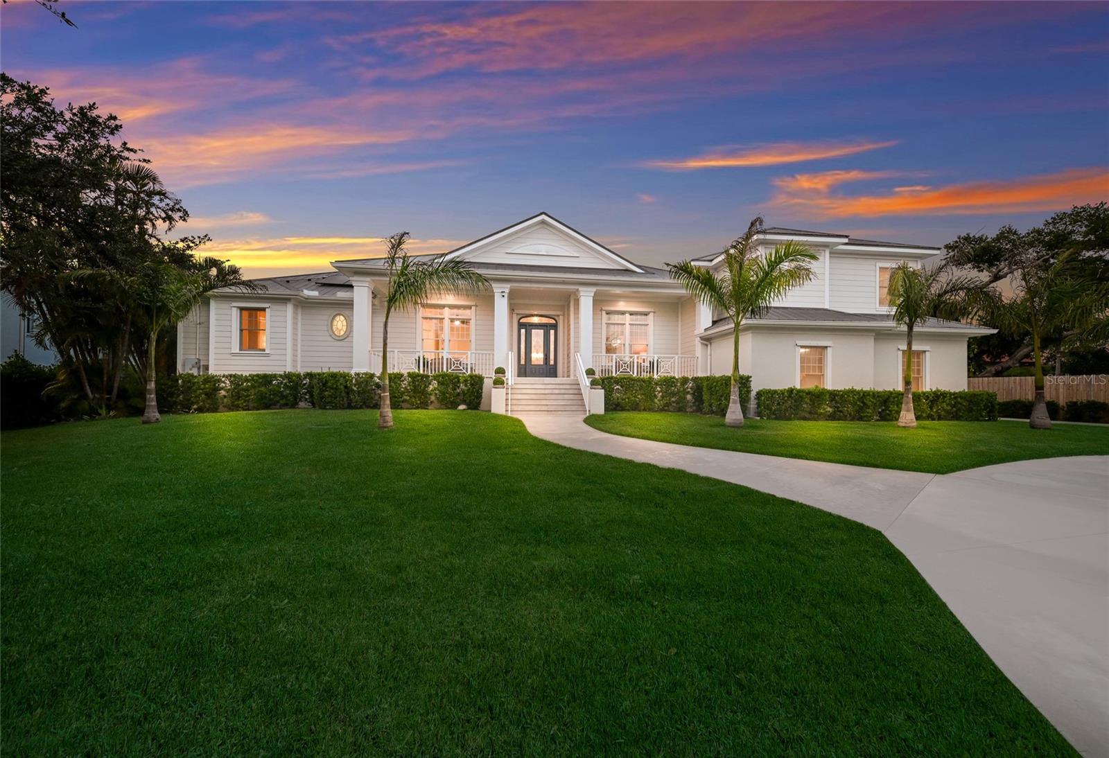 Tucked away at the end of a quiet road on a breathtakingly private one-acre homesite, this extraordinary luxury gated estate overlooks the serene waters of South Creek with the untouched natural beauty of Oscar Scherer State Park creating an incomparable backdrop. Completely reimagined with a sophisticated contemporary aesthetic, this custom-built residence blends timeless architecture with high-end designer finishes and luxurious modern upgrades throughout. From the moment you arrive, the home makes a striking impression with its expansive front porch, lush new landscaping, updated driveway and beautiful natural surroundings. Inside, every space has been thoughtfully transformed with premium materials, stylish finishes, and exceptional attention to detail. The result is a home that feels luxurious and inviting with a chic contemporary style rarely found. Featuring five bedrooms and 3.5 baths, the expansive floor plan is designed for both elegant entertaining and comfortable everyday living. Upon entering, stunning views of South Creek immediately draw your attention through the open living spaces and out toward the resort-style outdoor setting. The completely redesigned gourmet kitchen is the centerpiece of the home, showcasing KitchenAid® professional appliances, custom cabinetry, designer lighting, and luxurious finishes throughout. The spacious family room with a built-in electric fireplace flows seamlessly from the kitchen, while the formal dining room, butler’s galley and large walk-in pantry create the perfect setting for upscale gatherings and entertaining. Additional bonus spaces include a large media/game room with flexibility for a home theater, fitness space, billiards room or lounge area. Throughout the home, every detail has been elevated, including new flooring, custom wall accents, designer paint selections, premium fixtures, sophisticated lighting and beautifully renovated baths and living spaces. Anderson windows further enhance the quality and craftsmanship found throughout the residence. Upstairs, two oversized guest bedrooms feature walk-in closets connected by a Jack-and-Jill bath, while built-in desk spaces create ideal work-from-home or study area flexibility. Outdoor living is equally spectacular and has been totally reimagined. The new covered and screened lanai with outdoor kitchen overlooks the newly enhanced pool and spa area featuring a brand-new picture-frame pool cage and elegant paver deck. Beyond the pool, a dock extends toward the peaceful waters of South Creek, where panoramic natural views and complete privacy create a truly breathtaking setting. The dock and creek can accommodate a boat up to approximately 24 feet with direct access to the Intracoastal Waterway and beyond, offering an exceptional opportunity to enjoy boating, waterfront dining, and the waterfront lifestyle directly from your backyard. Completing the property is an oversized three-car garage with abundant space for vehicles and recreational storage along with an additional shed for tools and equipment. A one-year home warranty is included. The home features 69 solar panels that provide electrical service to the entire home and heated saltwater pool. This system is not financed. Private, stylish, luxurious and surrounded by nature, this exceptional waterfront estate offers a rare opportunity to own a fully transformed retreat in one of Nokomis’ scenic and secluded locations.