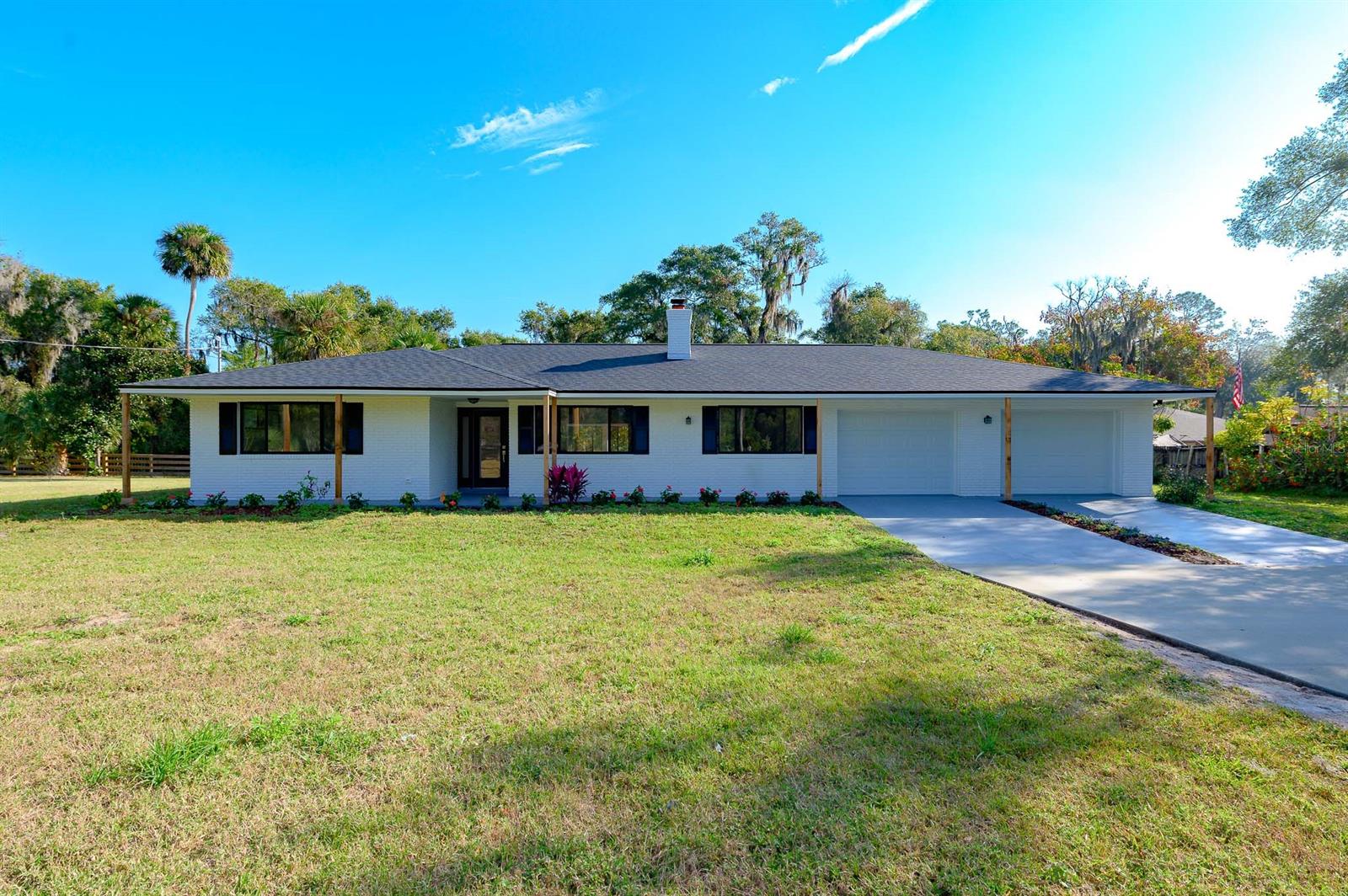 WOW! This is almost a new home on .73 acres! Reconstructed by luxury builder MJ Construction. Are you looking for a large 3 bedroom and 2 bathroom home?  Look no further! This estate home features almost 2500 sq/ft of living space, massive bedrooms, open floor plan, Florida room and bonus room that would be perfect for a home office. Homes like this are hard to find! This was a massive renovation and some the updates include: new roof, new AC, new bathrooms, new LVP flooring, new trim, baseboards, doors, garage doors, cabinets, drywall, quartz counters, penny tile bathroom floors, subway tile walls, SS appliances, etc.  That's over $110,000 in upgrades! NO HOA and city water. Only 15 minutes from the beaches of New Smyrna. Come enjoy the country while living minutes from shopping, restaurants and more! ;Water: City