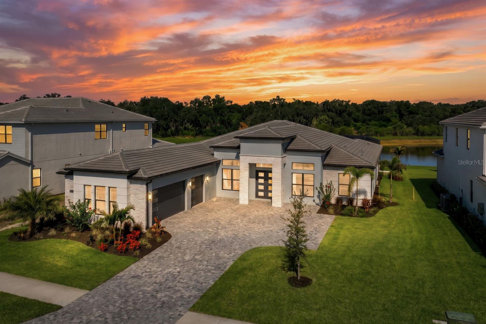 *Wake up to tranquil lake and preserve views—and end every day with spectacular Florida sunsets*

Welcome to this exceptional luxury residence completed in 2025 in the highly sought-after community of Monterey at Lakewood Ranch. This transitional-style home is perfectly positioned on an oversized 13,138 sq. ft. homesite and offers 3,340 sq. ft. of thoughtfully designed living space with 4 bedrooms, 3 full bathrooms, a powder bath, a private office, and an oversized 3-car garage.

Inside, the open-concept floor plan features soaring ceilings, tray ceilings in the foyer, great room, and primary suite, tile flooring throughout the main living areas and bathrooms, plush carpeting in all bedrooms, and designer cabinetry in elegant marine and light gray tones. Expansive picture windows and sliding glass doors fill the home with natural light while creating a seamless connection to the outdoor living space.

Beyond the great room, outdoor living takes center stage with breathtaking west-facing lake and preserve views, exceptional privacy with no rear neighbors, and unforgettable Florida sunsets. The screened lanai features a marble pool deck surrounding a saltwater pool with a cascading waterfall, custom lighting, and a natural gas pool heater for rapid, year-round enjoyment. Two covered lanais provide the perfect setting for outdoor dining, relaxing and shaded seating, while the pre-plumbed outdoor kitchen area is ready for your custom design. Whole-house gutters and a fenced side yard complete this private outdoor retreat.

The gourmet kitchen is a showpiece, featuring a premium appliance suite highlighted by a Sub-Zero refrigerator and KitchenAid stainless-steel appliances, including a natural gas cooktop. Bright quartz countertops, an oversized waterfall island, a custom dry bar with wine chiller, and a spacious walk-in pantry complete the space. Quartz countertops continue throughout all bathrooms for a cohesive designer finish, while the powder bath is enhanced with custom wallpaper. A separate laundry room offers built-in cabinetry along with a top of the range GE washer and gas dryer combination.

The privately positioned primary suite offers a peaceful retreat, while the additional bedrooms provide flexibility for family, guests, or multigenerational living.

This highly desirable Toll Brothers Ballast model offers all the advantages of new construction without the wait, including a transferable builder warranty. Hurricane-impact windows throughout provide durability, enhanced storm protection, energy efficiency, and peace of mind. Additional energy-efficient features include spray foam and masonry foam insulation, a tankless water heater with a recirculation pump for near-instant hot water, and natural gas service with the ability to easily add a whole-house generator.

Residents of Monterey will enjoy a future resort-style amenity center anticipated to open in Fall 2027, featuring a resort-style pool, pickleball and tennis courts, walking trails, a dog park, and additional recreational amenities. Ideally located within the award-winning Lakewood Ranch master-planned community, the home is just minutes from top-rated schools, premier shopping, dining, and the Gulf Coast's renowned beaches.

This exceptional residence combines luxury finishes, breathtaking sunset views, energy-efficient construction, and one of Monterey's most desirable homesites. Schedule your private showing today.